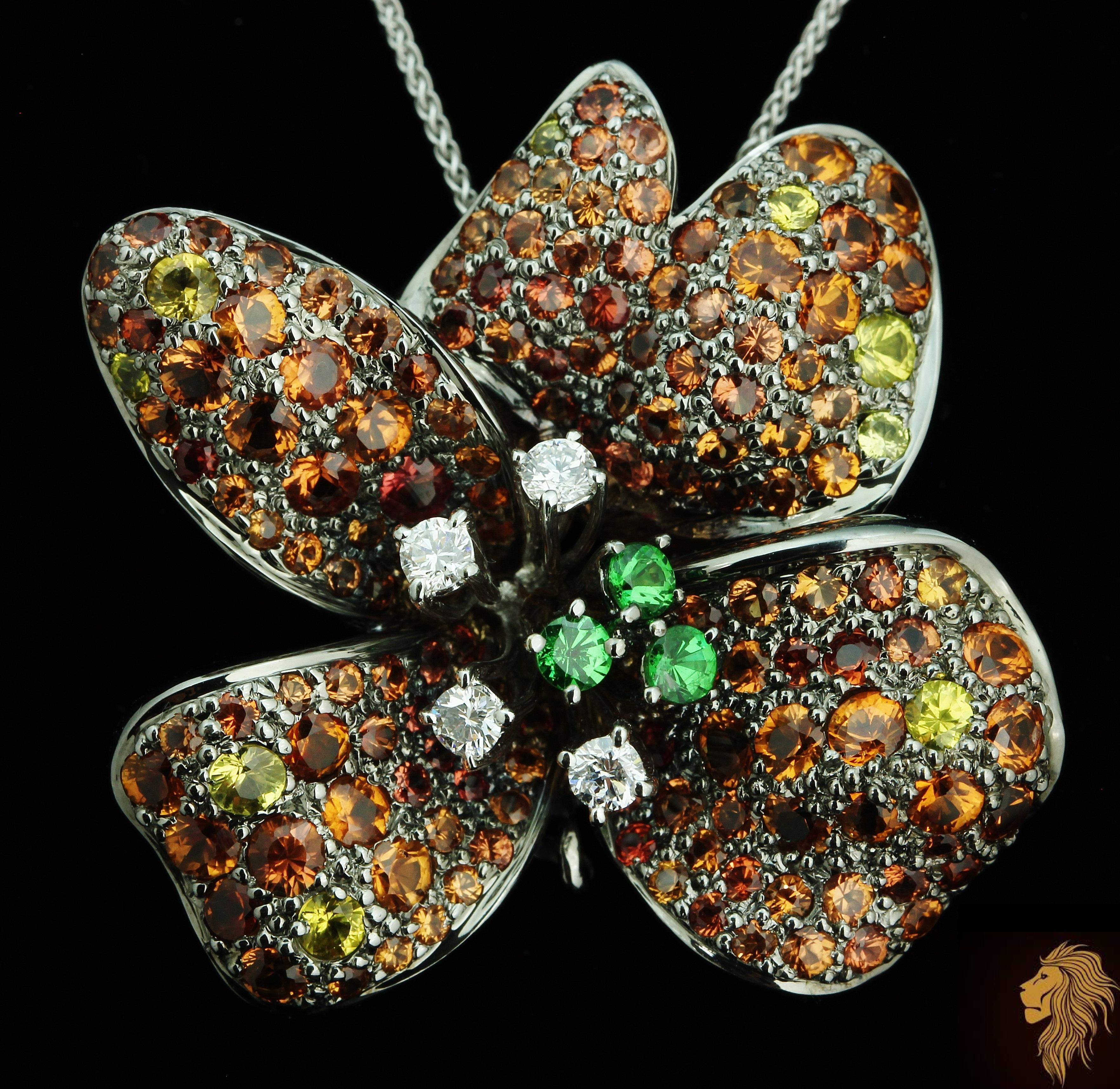 Designer Pendant brooch (can be worn both ways with dedicated pin for the brooch and hook for the pendant use)

NEW with tags, Tag Price $9750

18K solid White Gold

8.21 CWT Diamond and AAA Tsavorite Garnet and multi-color Sapphire, all natural and