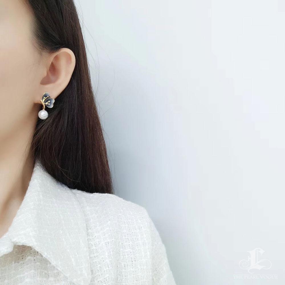 These elegant earrings feature lustrous, high-quality South Sea pearls that radiate timeless sophistication. The design is brought to life with two intricately crafted butterflies, created using advanced diamond-dust sandblasting techniques for a