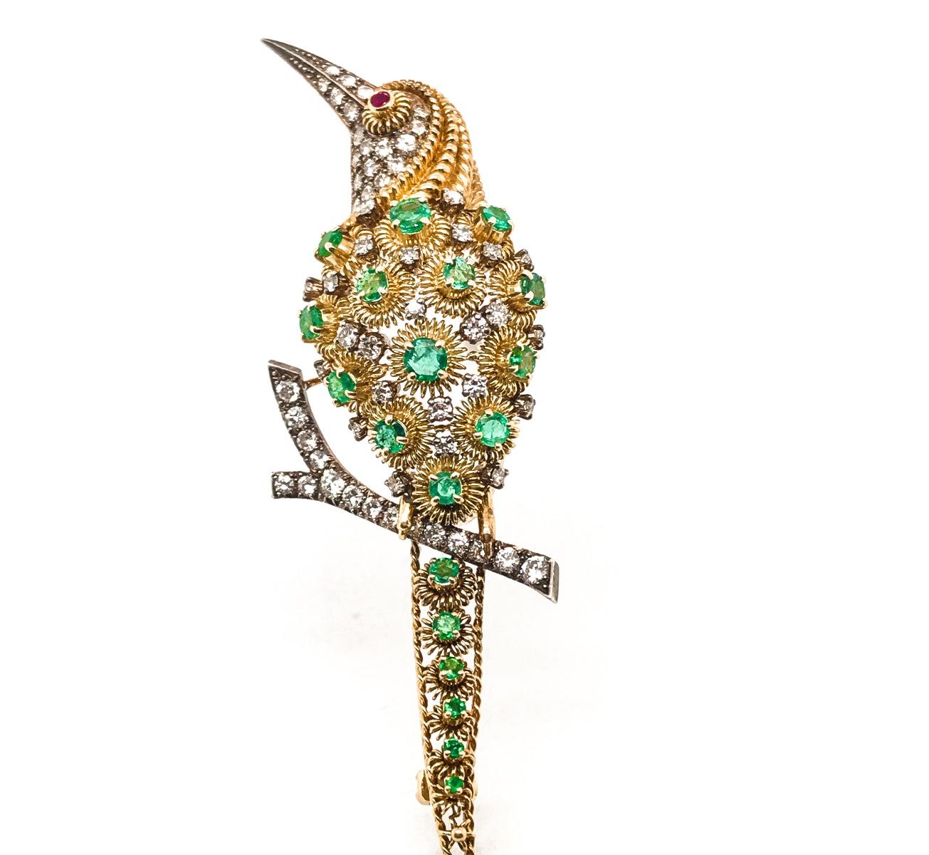 Filigree Styled 18K Bird Brooch, set with an assortment of dazzling diamonds and emeralds- a single red ruby sits within the eye of this 1940's masterpiece

SKU#PB-01938