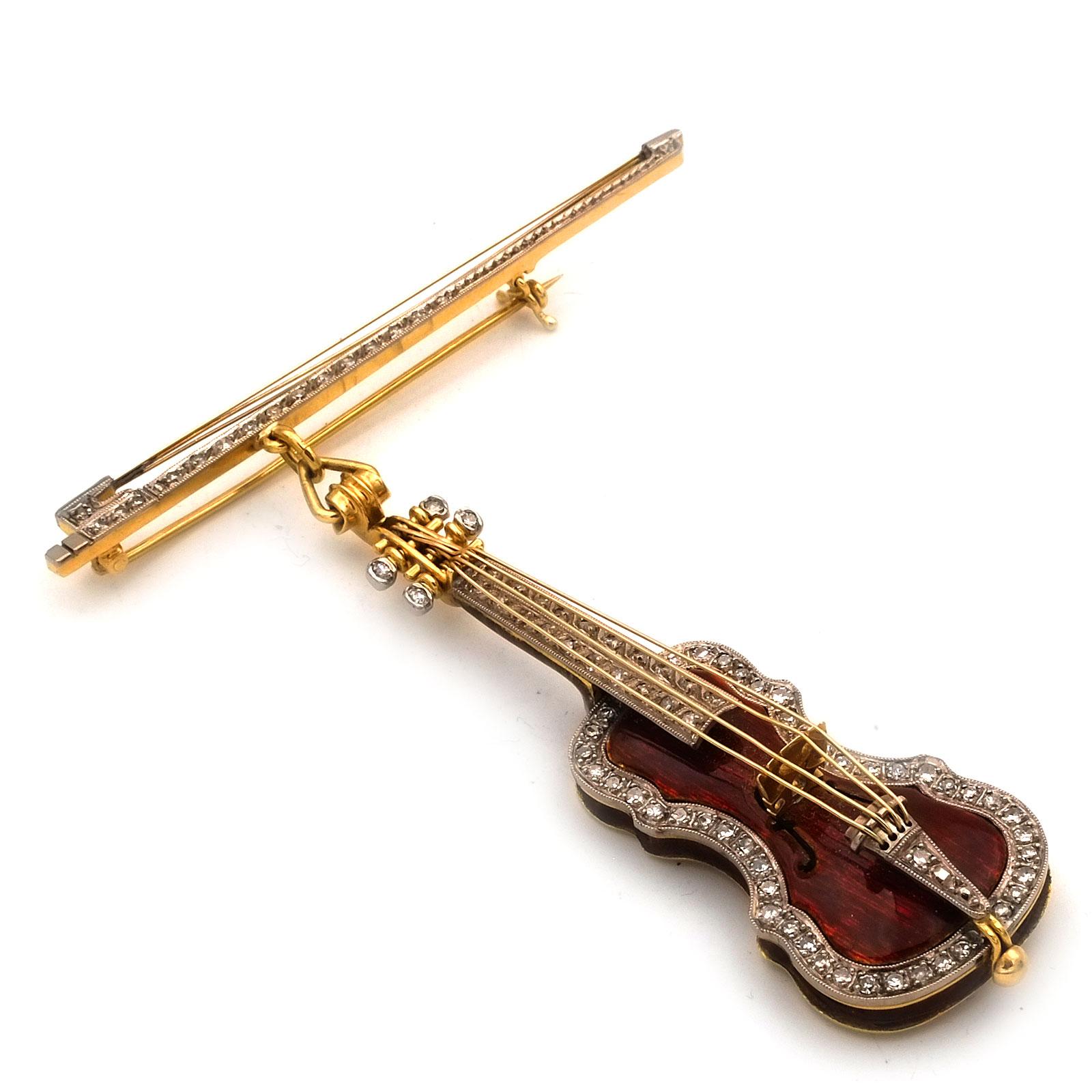 18K Gold Diamond and Enamel Stradivari Violin and Bow Brooch, circa 1930

Wonderful 18K  gold and diamond brooch in the shape of a lifelike Stradivarius violin, flexibly mounted on the accompanying violin bow, which also serves as a needle.
