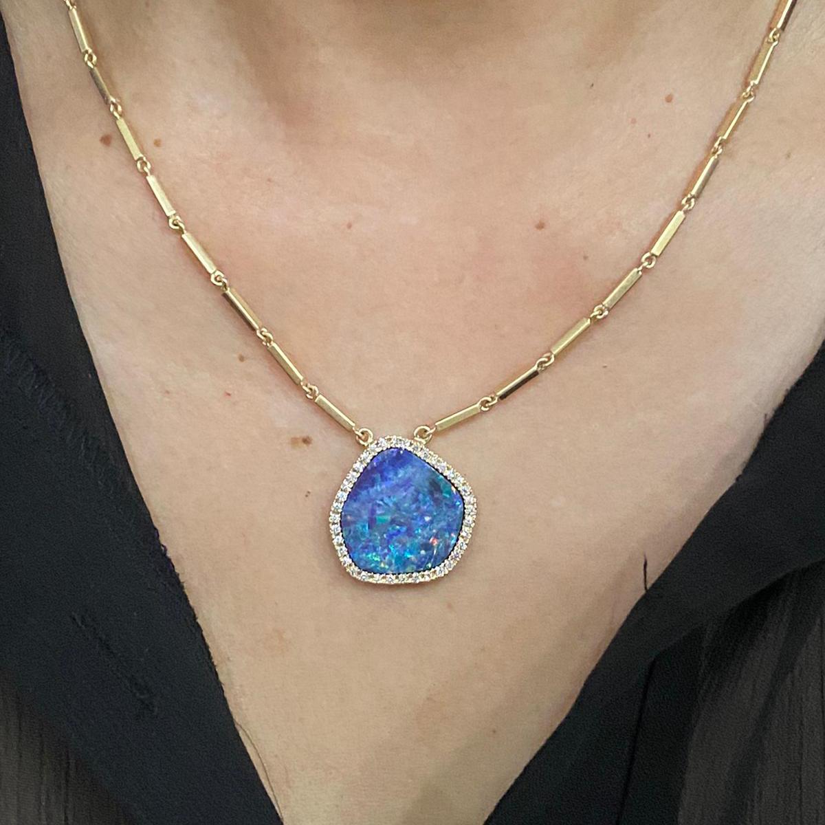 Opals are perhaps the most colorful of gemstones and this unique stone is a great example.
The 11 carat opal is surrounded by 0.37cts of Diamonds and on a hand made, solid gold chain.  Chain length can be customized and is a great example of Nancy's