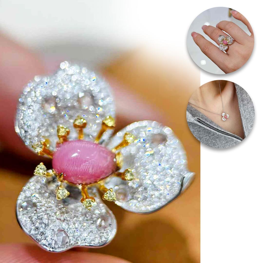 A graceful embodiment of femininity, this orchid-inspired jewel is both a statement ring and an elegant pendant. At its center lies a 1.3ct flamingo pink conch pearl with a strong flame pattern, a rarity in conch pearls of this size.
The flower