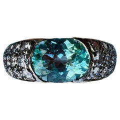 Anillo de compromiso de oro de 18 quilates con diamante certificado por el GIA de 4 quilates de turmalina paraiba ovalada