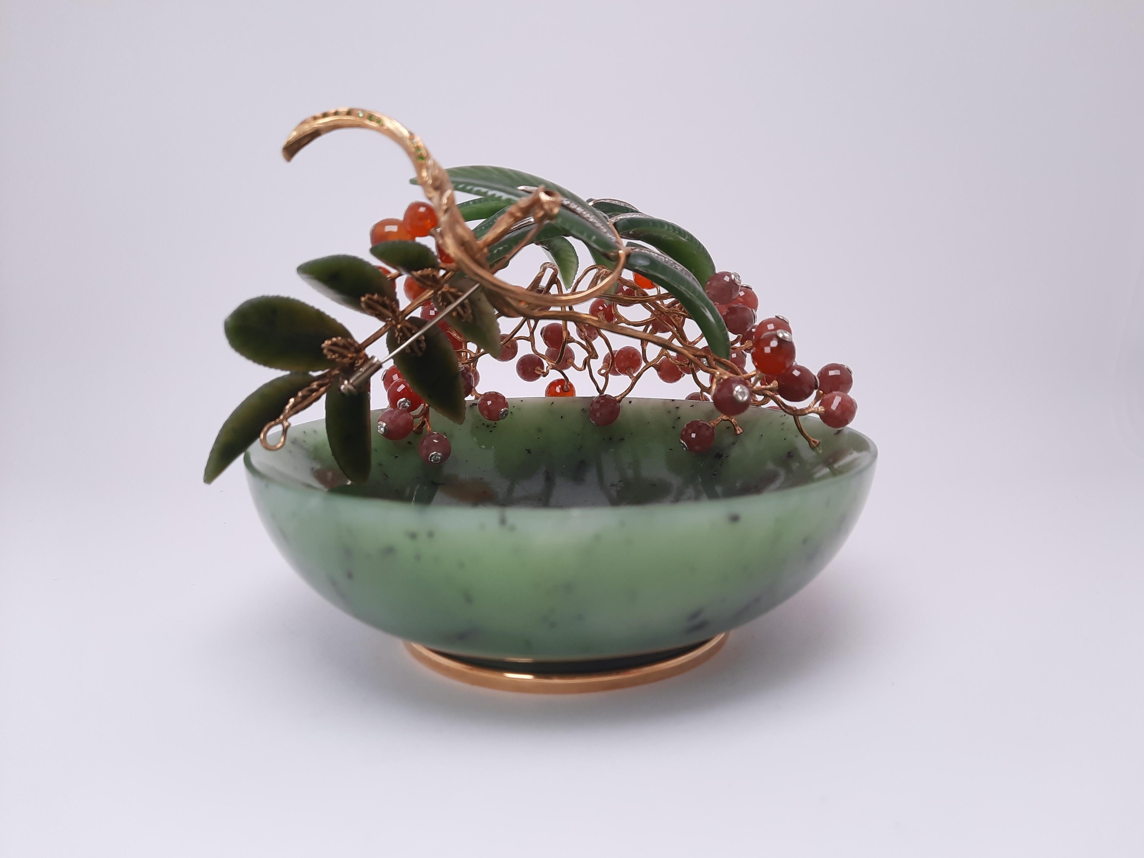 An interior jewellery art object, Rowan berry, handmade by MOISEIKIN🄬 was created as a gift to preserve harmony, happiness in the family and a cordial relationship with each other. The carved Ural Nephrite base is covered with juicy Rowan berries