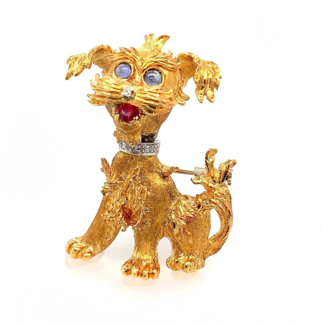 A delightful and finely executed 18k/14K gold brooch of a Schnauzer dog with a diamond nose and collar, sweet sapphire cabochon eyes and a ruby tongue.
The pin and collar are in white gold.

The head of the dog has a surprising movement mechanism,