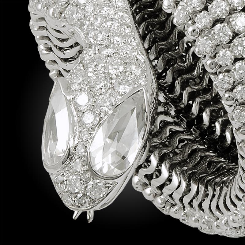 Contemporary Diamond Coiled Serpent Bracelet in 18k White Gold.

This bejeweled bracelet is compiled by circular diamonds configured in a continuous bombé shape; designed as a serpent coiling around the wrist numerous times. The convex nature of the