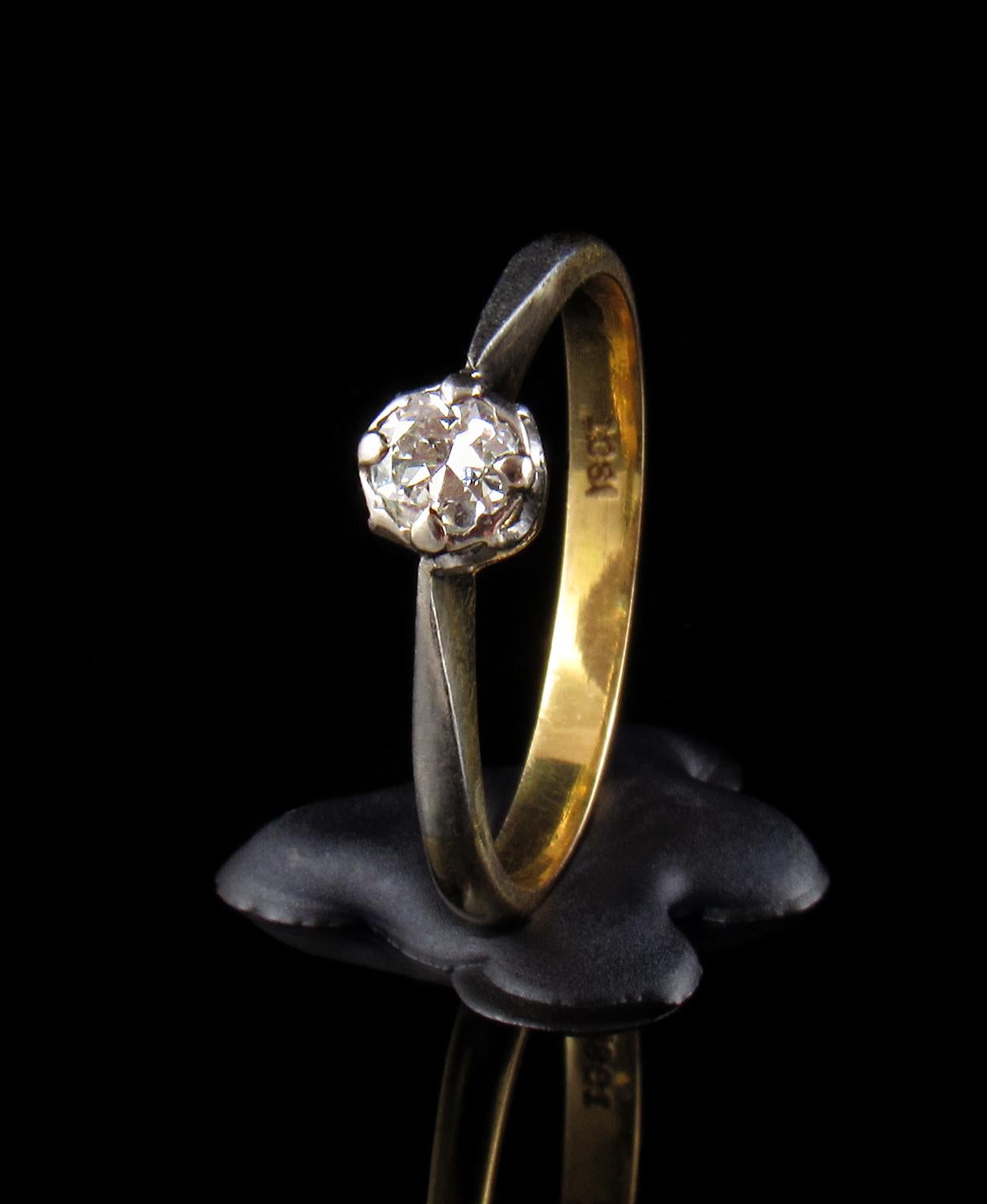 A lovely 1950s engagement ring with a very pretty setting and bright diamond of excellent clarity.

A very beautiful diamond ring with a single round old cut claw set diamond of 0.22-carat set in a solid 18-karat yellow gold smooth knife edge