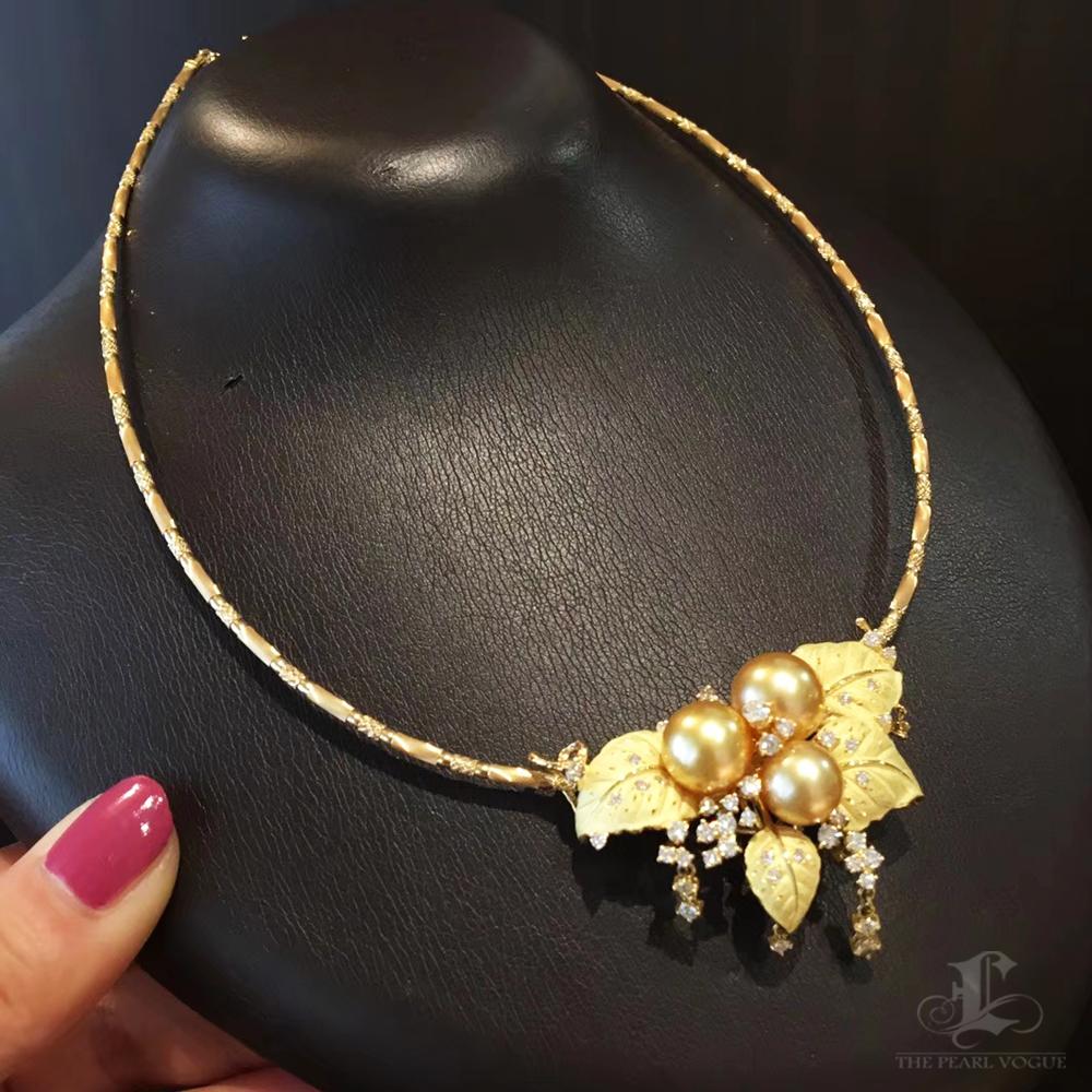 Radiating timeless elegance, this high-jewelry piece features lustrous Golden South Sea pearls in a symbolic grape cluster design, representing abundance and prosperity. The pearls are complemented by intricately sculpted leaves adorned with diamond
