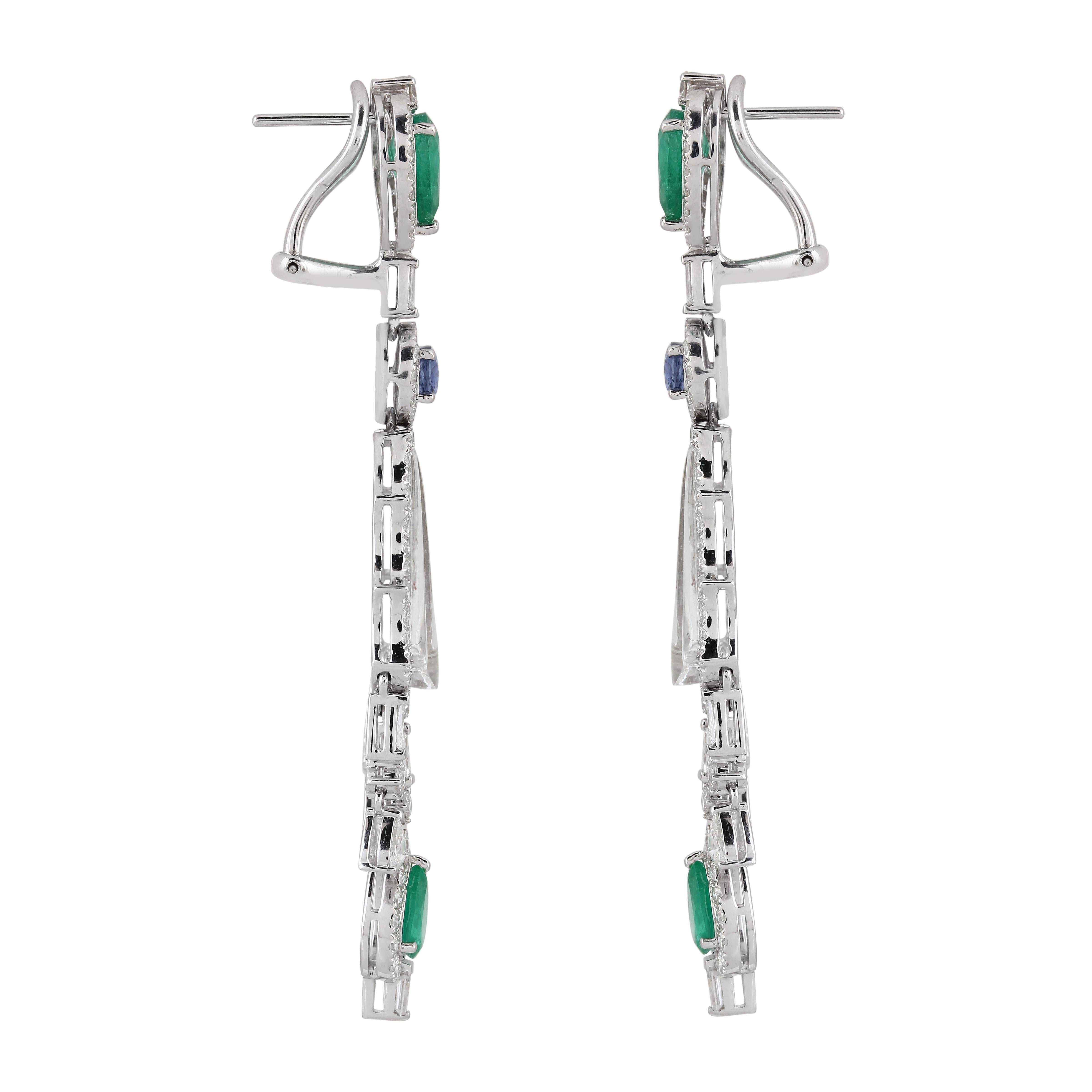 The stunning 10.47 carat Emerald, Blue Sapphire, Crystal, and 3.39 carat Diamond drop earring has a faultless design. With a surmount of pear-cut emeralds flanked by round-cut diamonds, it features an uncommon yet excellent pattern. After that, it's