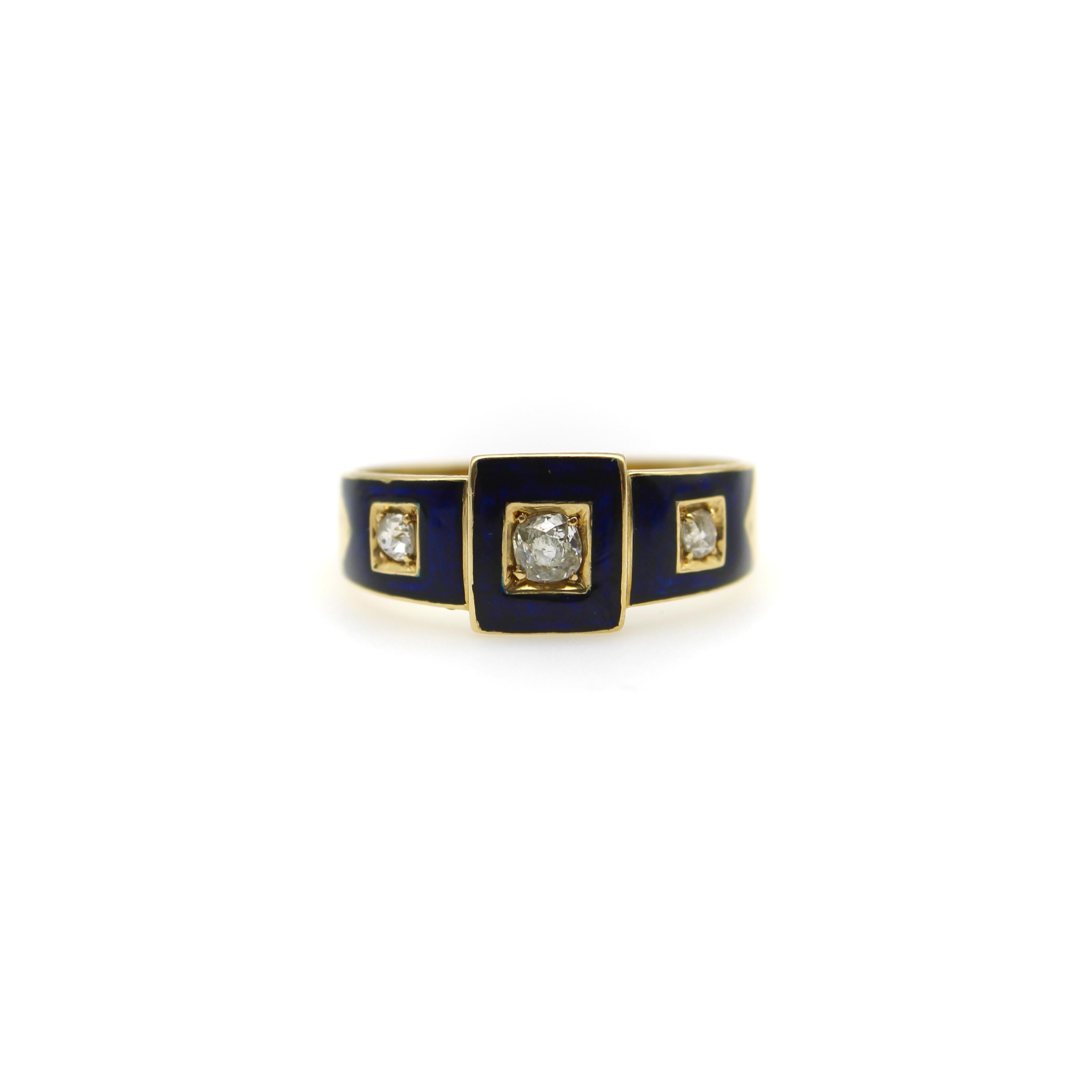 This 18k gold early Victorian ring features three Old Mind Cut diamonds encased in blue enamel square details. The diamonds are housed in a square, carved out setting in the 18k gold that creates a gorgeous contrast against the navy blue. The center