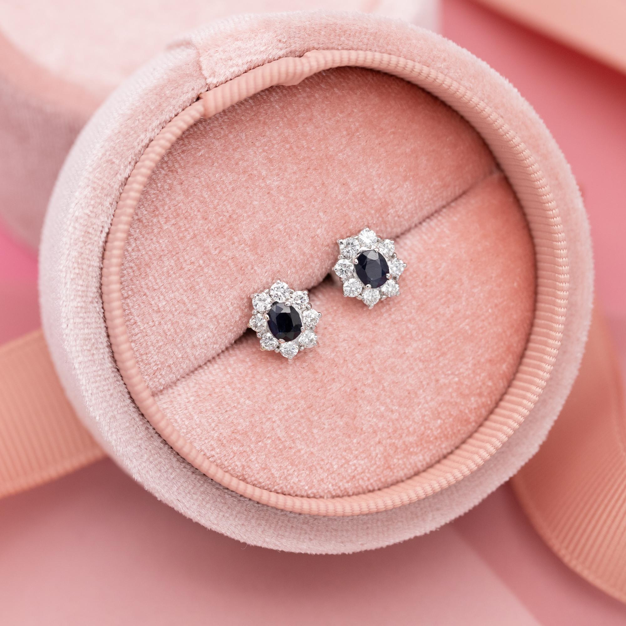 For sale is this 18 K white gold pair of diamond and sapphire earrings. This beautiful pair is set with a total of eighteen brilliant cut diamonds which combine for approximately 0,55ct. They are set in a floral composition in a white gold setting