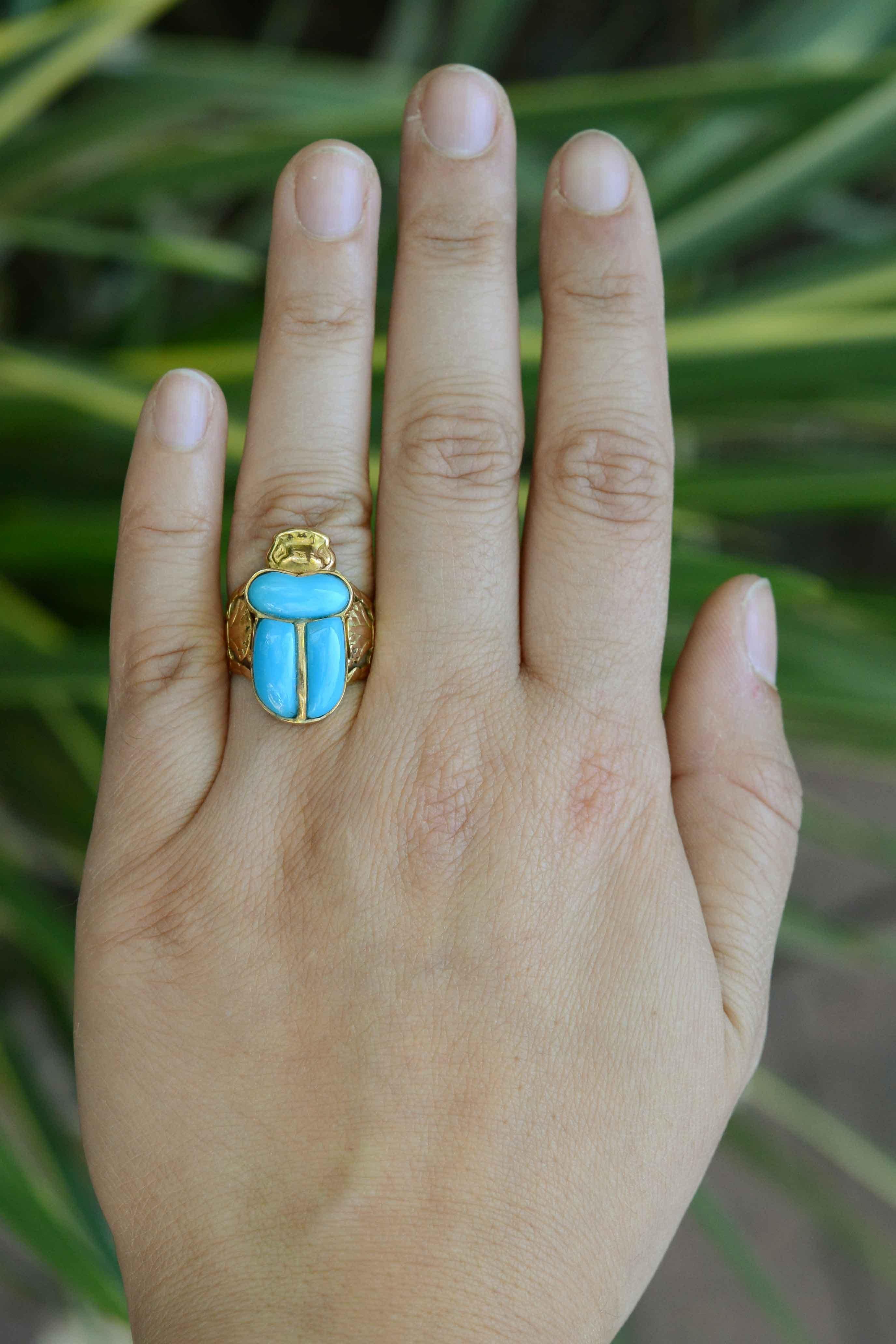 A vibrant and unique Persian turquoise and 18k gold ring. This vintage ring is styled after highly refined ornamental ancient Egyptian jewelry. The finely hand engraved, rich yellow gold marvelously complements the lively turquoise. A truly