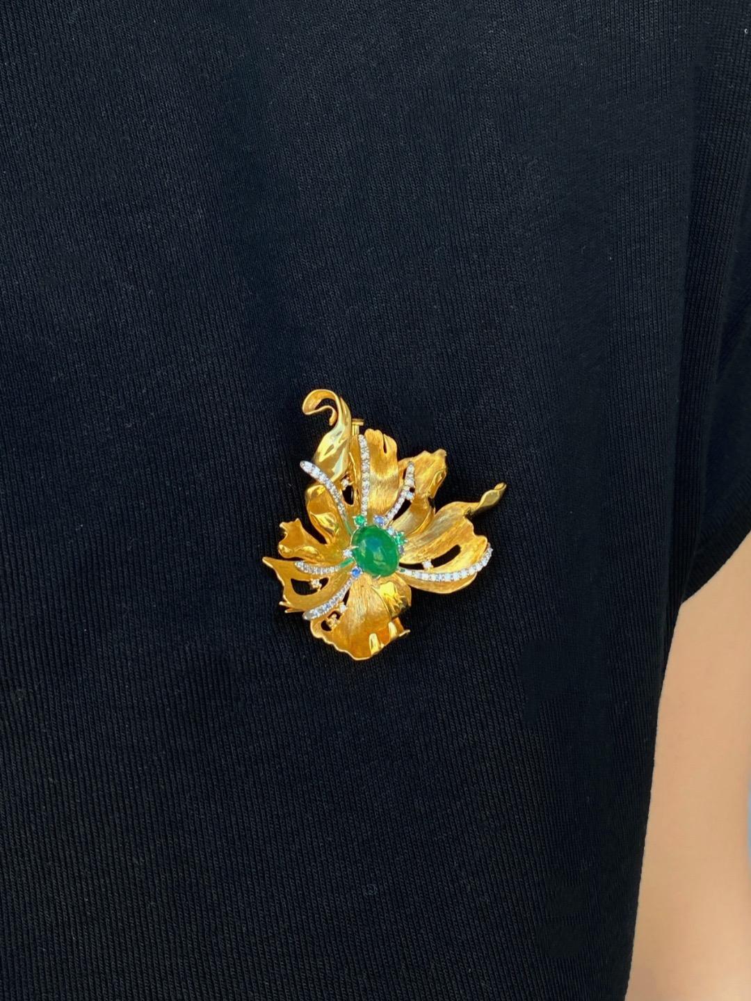 2.12 Carat Emerald Gold Brooch With Diamonds and Gems 

Emerald Stone: 2.12ct
Diamonds: 0.40ct
Gems: 0.08ct
Total weight: 12.63grams

This 18K gold brooch, centered around a 2.12ct natural emerald, is a symphony of nature-inspired luxury. What makes