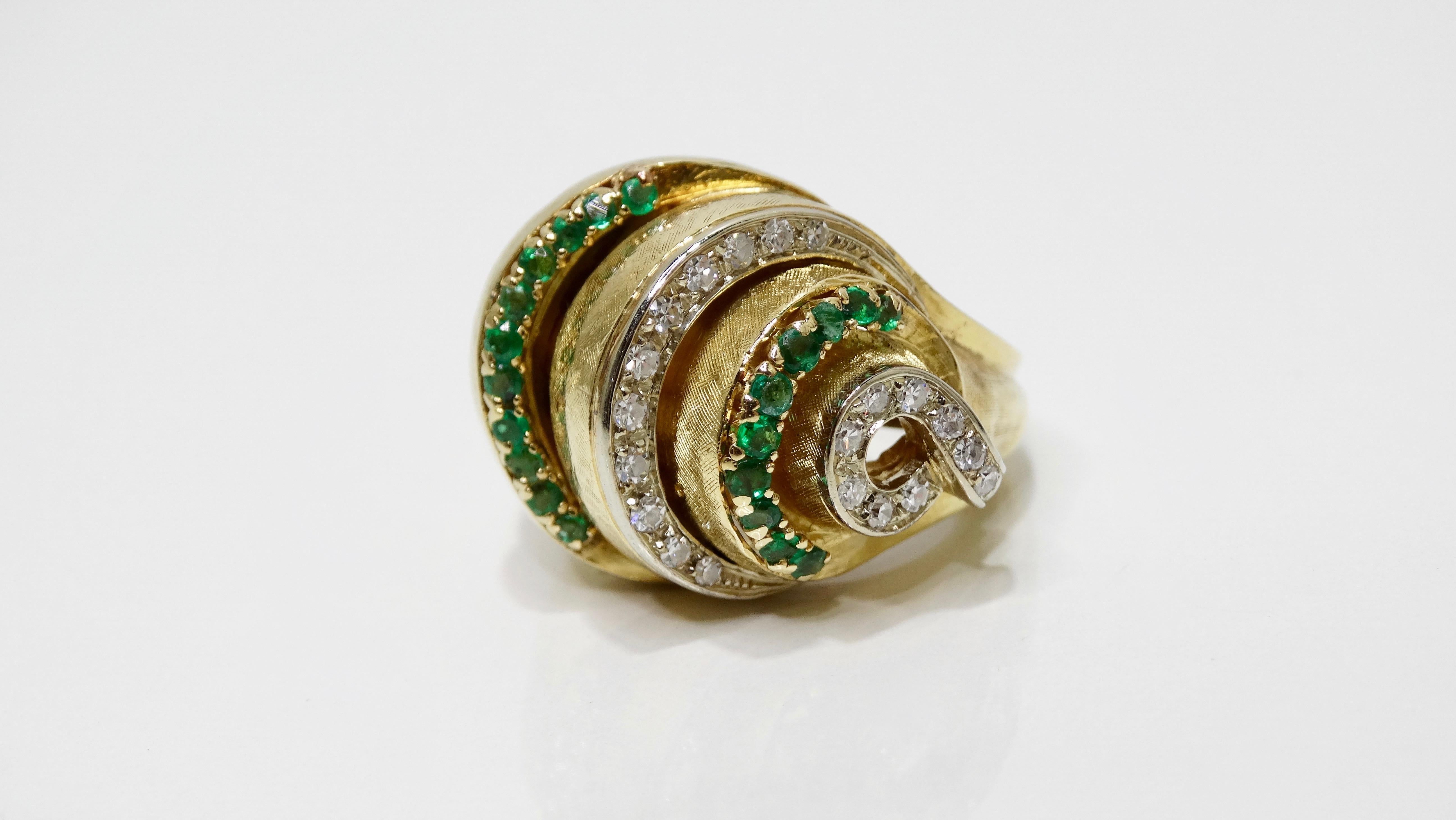 Bring on the cocktail ring that is! Circa mid-20th century, this gorgeous 18k Gold cocktail ring is crafted into an armadillo style band with tiered rows of brilliant round cut Diamonds and Emeralds in a prong setting. Rings total weight in grams is