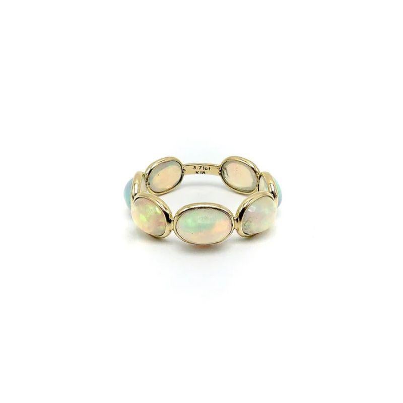 Enjoy flashes of orange, green and pink while wearing this lovely gemstone ring.  Made up of seven open backed opal cabochons set in an 18k gold band, these bezel set opals have endless kaleidoscopic colors to admire. It's a simple design that