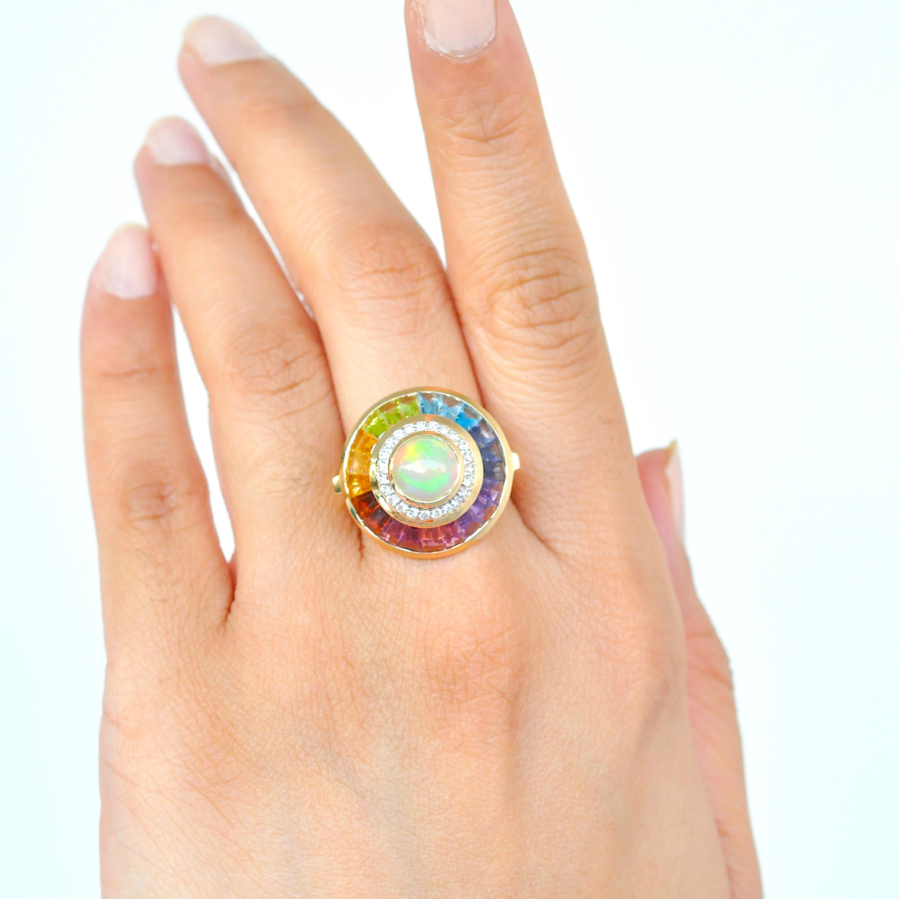 18k gold ethiopian white opal multicolour rainbow baguette circular diamond ring.

Celebrating the iridescence of the natural ethiopian white opal with bright fire colors is this beautiful dome shaped cocktail ring. To accentuate the beauty of the