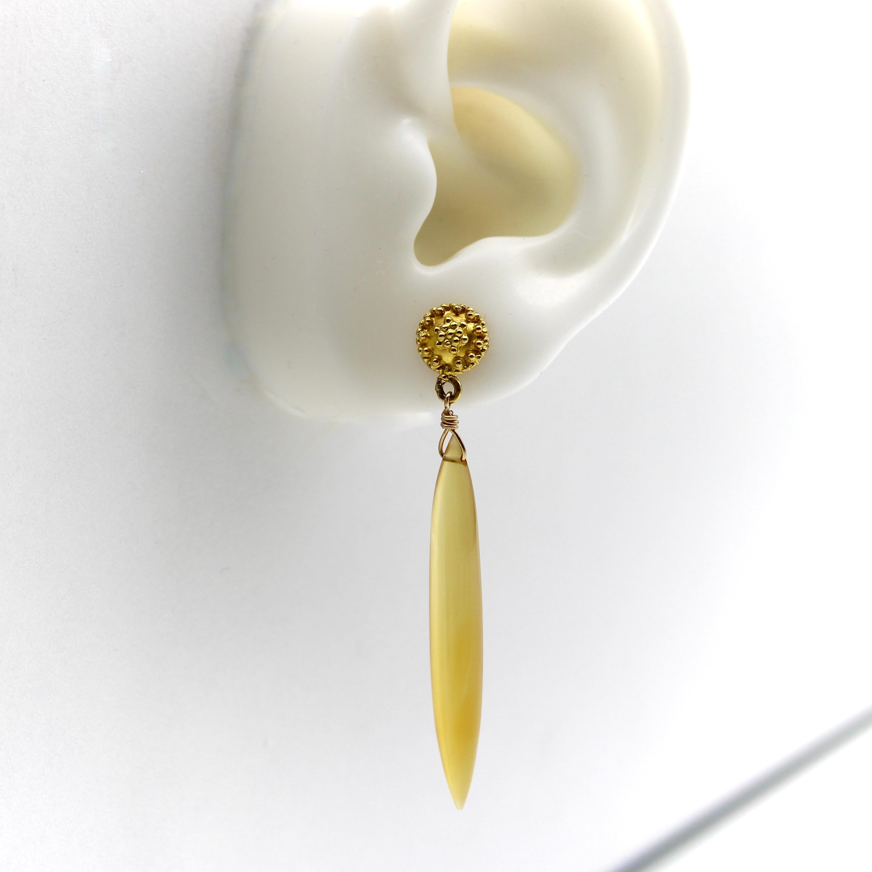 Part of Kirsten Corner’s Signature Line, this one-of-a-kind pair of drop earrings glow with a honey-colored amber hue that comes to life in both the 18k gold tops and the chalcedony gemstone torpedos that dangle below them. We found these vintage