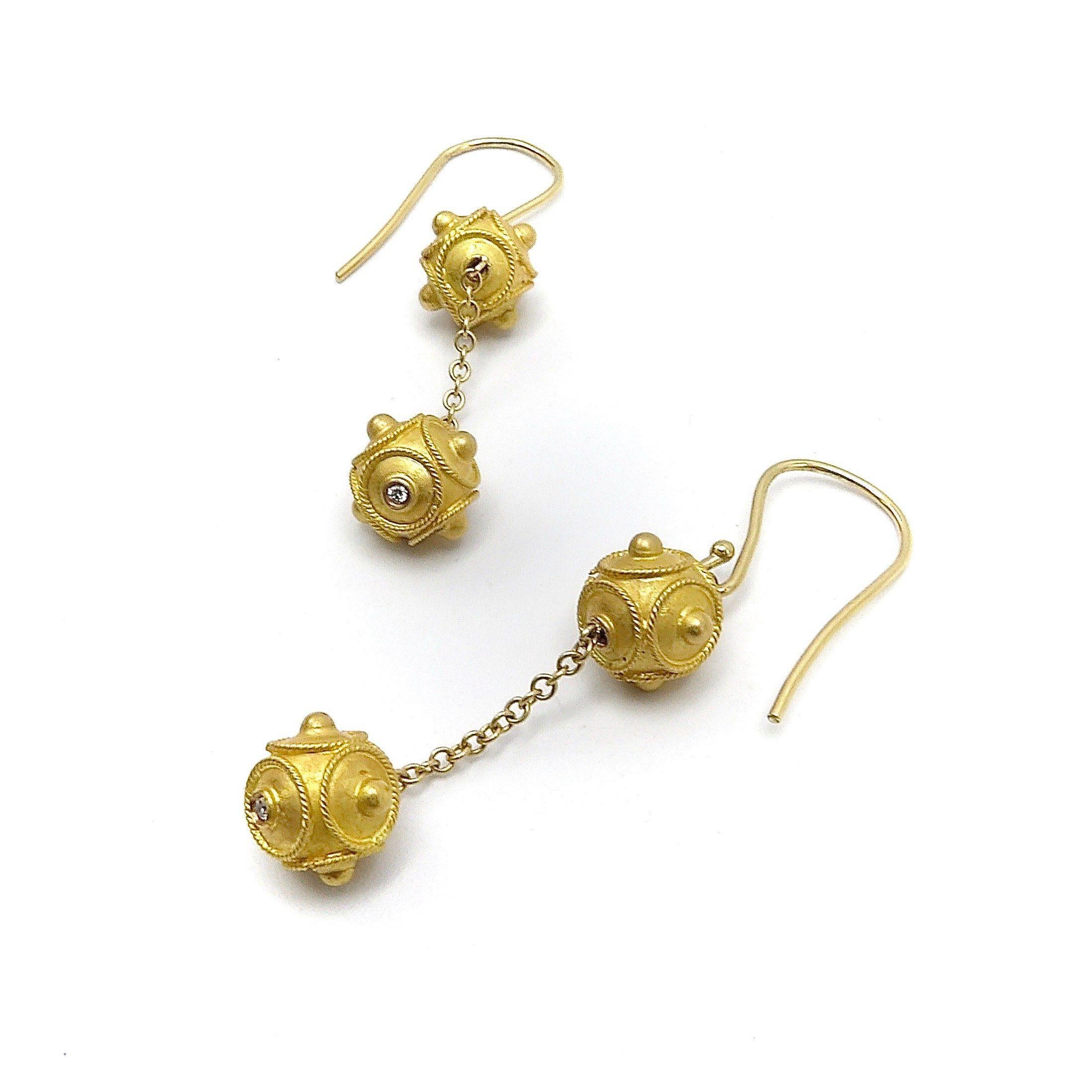 This a stunning pair of 18K Gold Etruscan Revival Double Ball Dangle Earrings. Each earring has two intricately Etruscan Revival twisted wire worked balls or beads of 18K gold. They attach to a shepherd hook ear wire of 18K gold. They are suspended