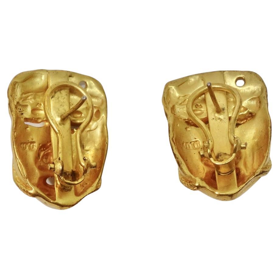 Do not miss out on these incredibly unique 18K gold stud earrings circa 1960! Gorgeous gold studs featuring a detailed face motif draw in the eye. Look closely and notice how intricate the engravings are, these earrings are a wearable work of art