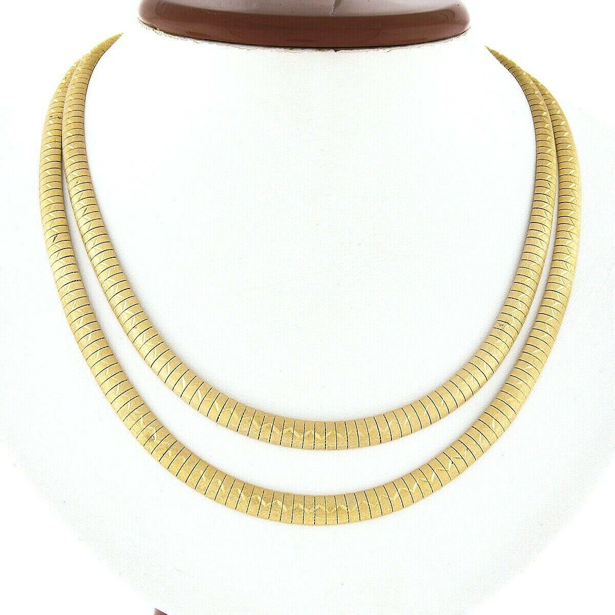 This beautiful necklace and bracelet set was crafted from solid 18k yellow gold and feature multiple straps of very well made fancy omega link design throughout. The bracelet consists of 5 rows, all of which have a matte finish adorned with an