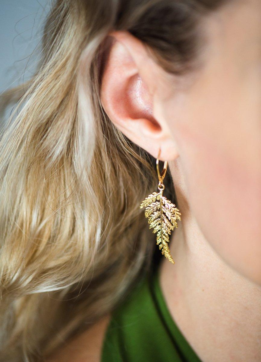 These exquisite hand-carved 18K Gold Fern Earrings embody the delicate beauty of nature, meticulously crafted with Jennifer Rutheny’s signature artistry. Inspired by real fern leaves, each piece is sculpted using the lost wax method, ensuring no two