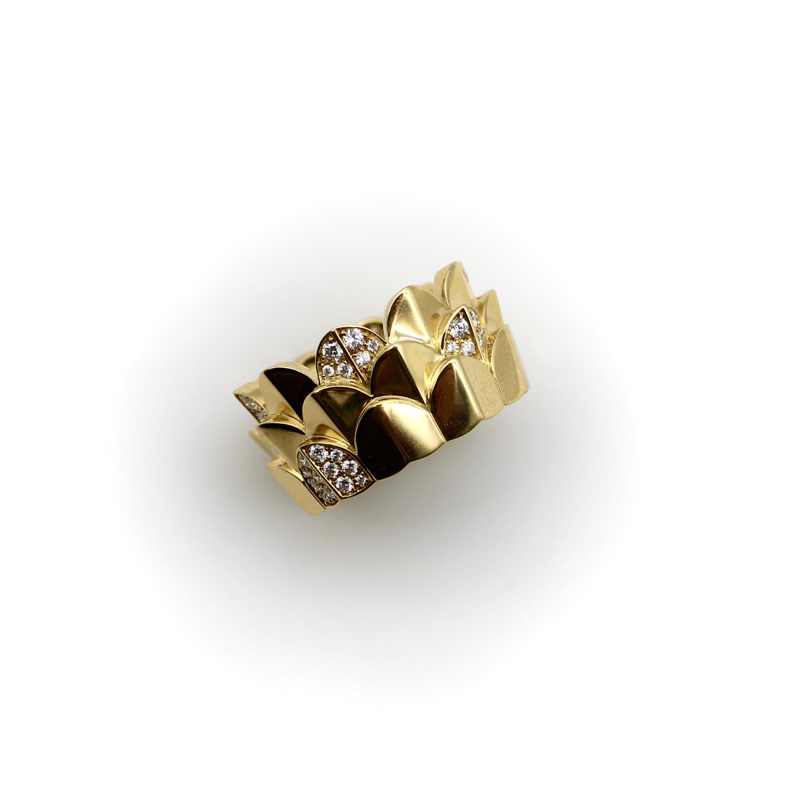 This 18k gold and diamond pave band ring is befitting of a queen! The triple arc motif is an iconic Fred of Paris design, with three layered bands reminiscent of flower petals or the scales of an aquatic creature. Within the the motif, some arcs
