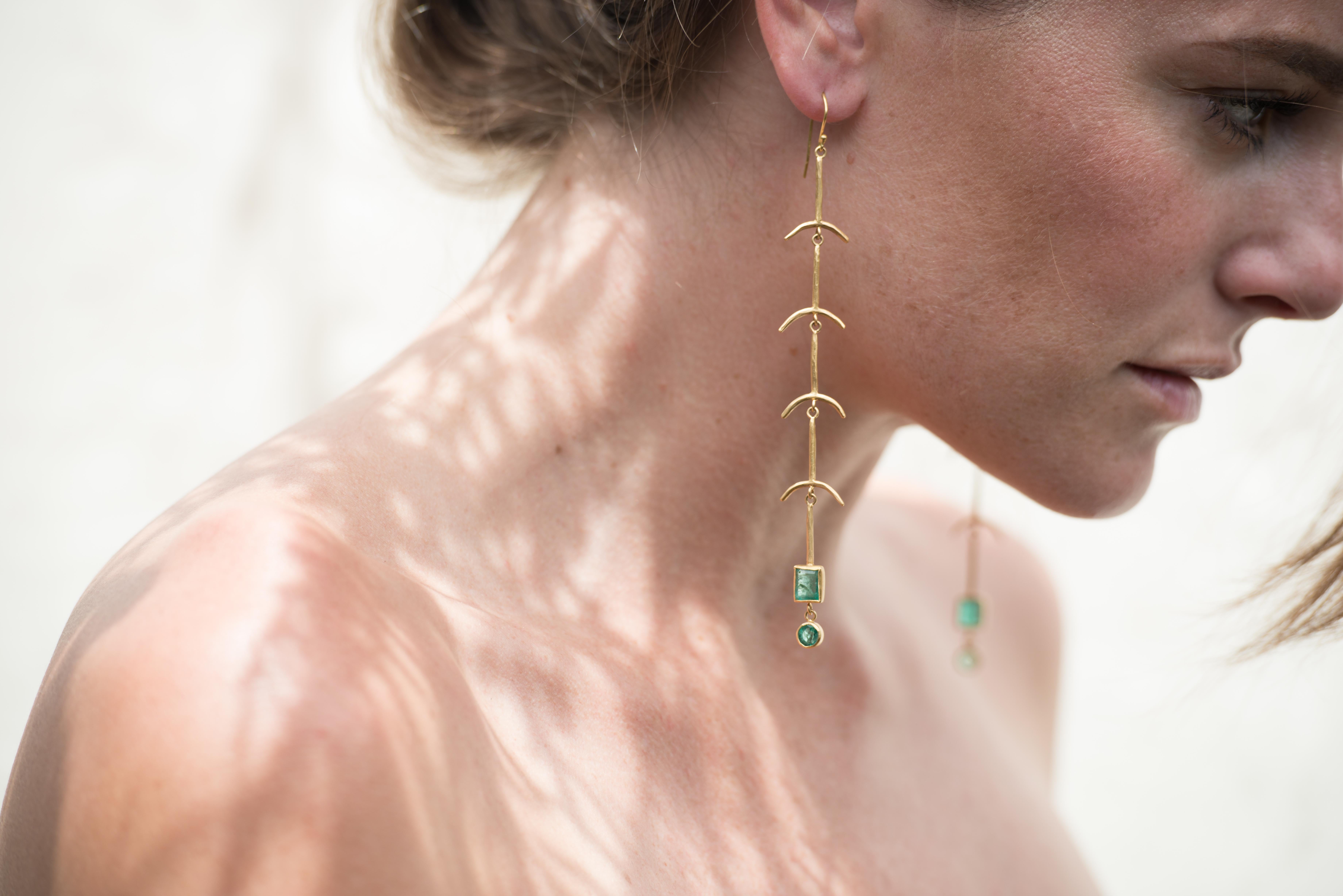 Completely handcrafted, our long shoulder dusters featuring Gemfields' ethically sourced Zambian emeralds bezel set in matte 18k recycled gold are from our Bones Collection. Each section is hand forged to create a feel of ancient jewels unearthed