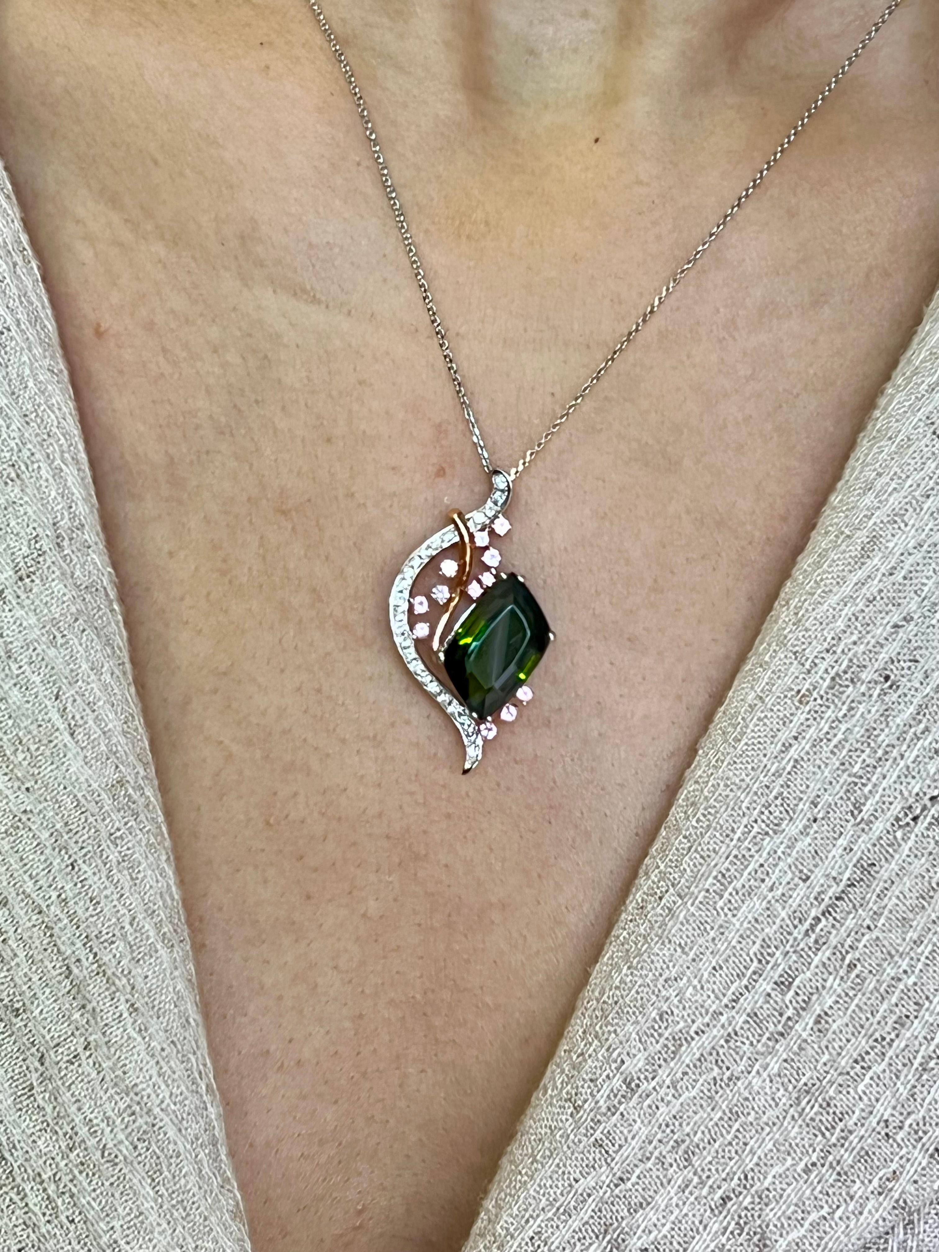 Please check out the HD video. This is a versatile piece of jewelry. You can wear this pendant dressed up or down. The green tourmaline pendant is made of 18k white and rose gold, pink sapphires and diamonds. There is one larger green tourmaline. 12