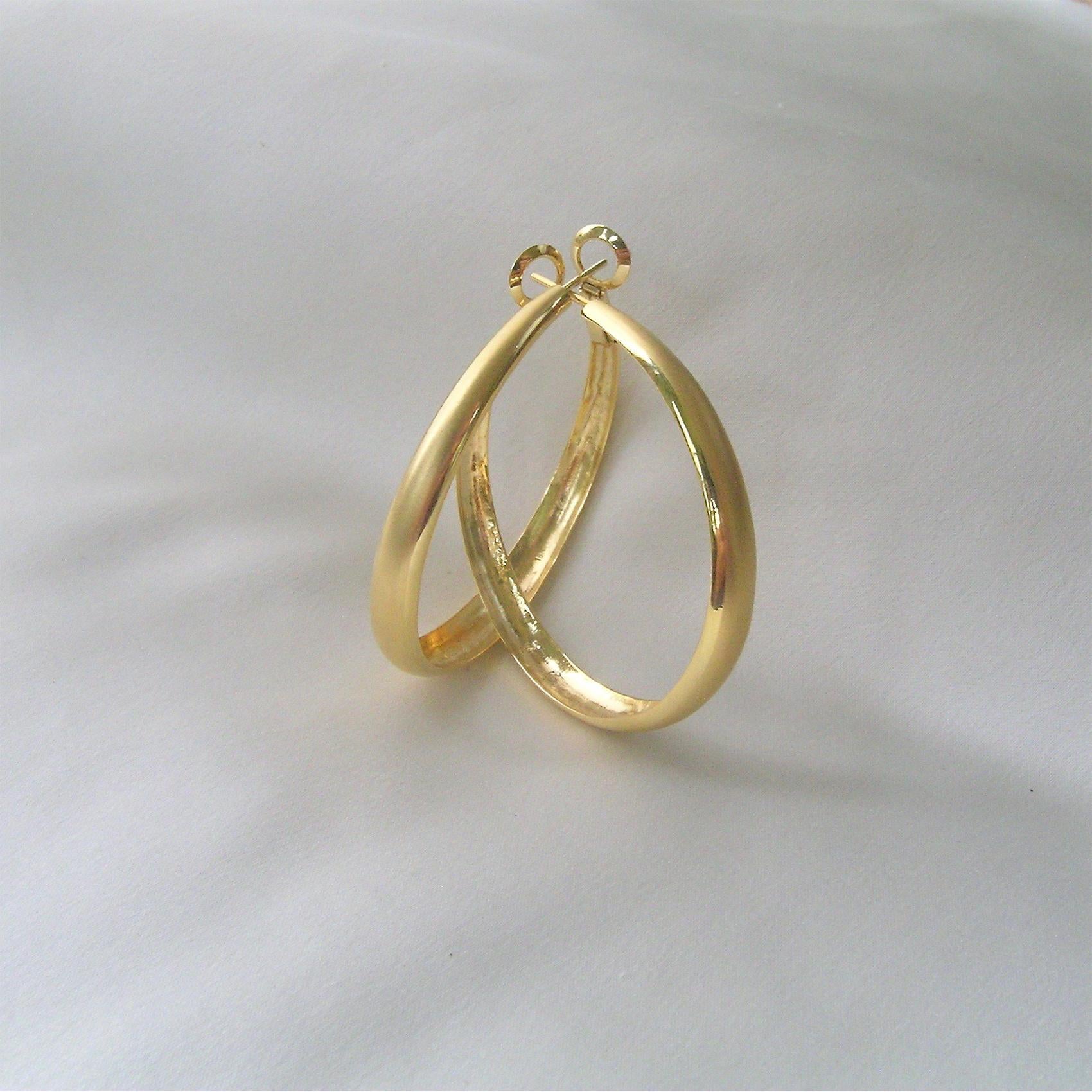 This version of a hoop earring is different in that there is a lot of gold shown in the wide, slightly curved front of the earring.  Most hoops are thin or consistent width all the way around.  These taper to the back so that they are super light on
