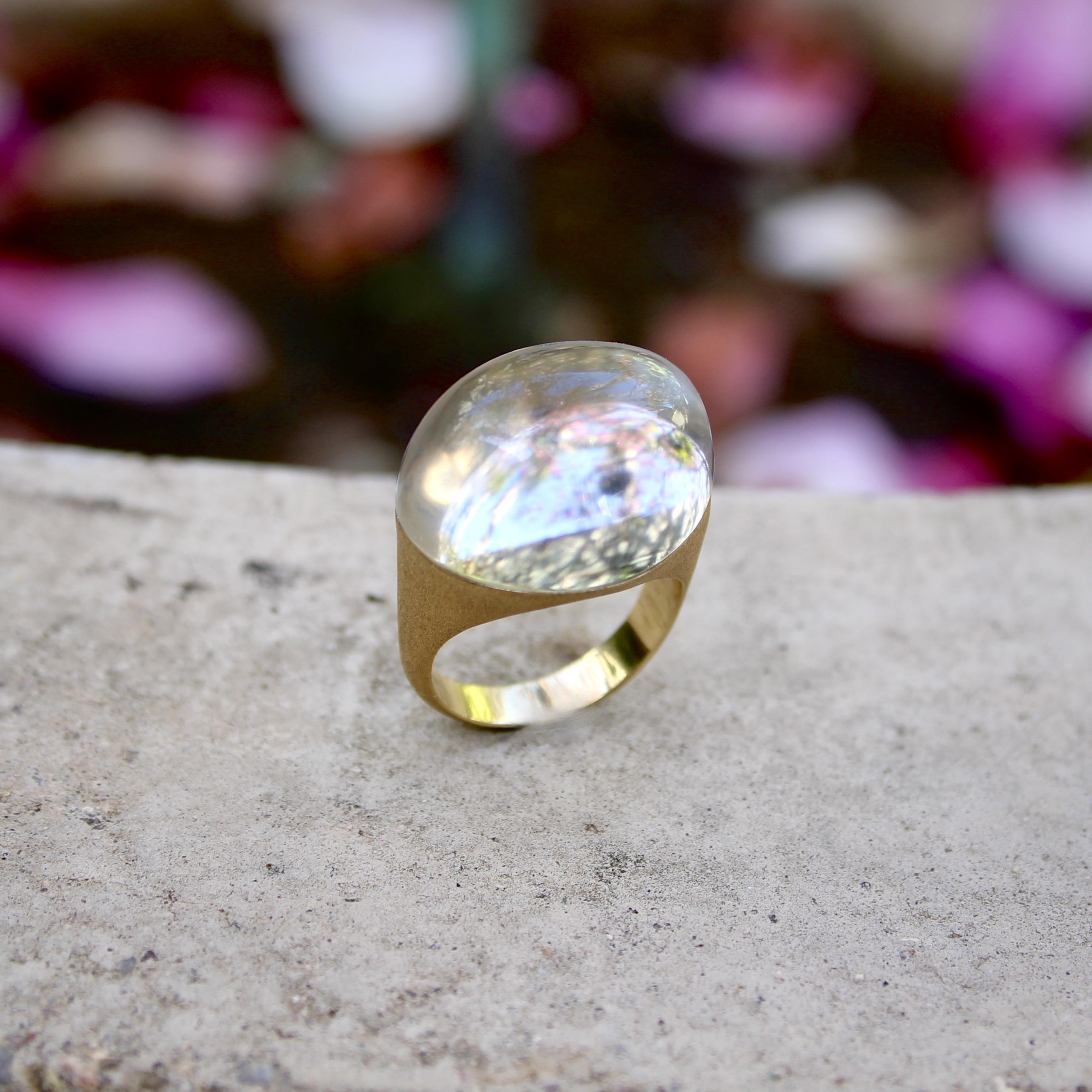 Designed by Brazilian jeweler H. Stern, this 18k gold rock crystal ring is part of the Golden Stones collection. It is a sculptural piece with a very high dome: the rock crystal cabochon sits approximately 1/2 an inch above the finger. The stone is