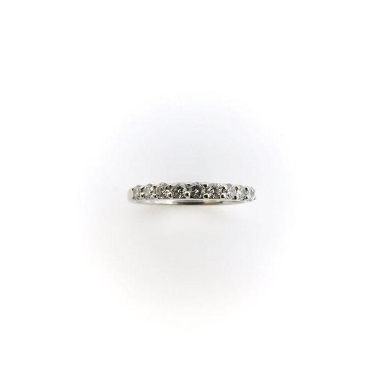 This is a beautiful half eternity diamond band by Jaffe .  It has 11 2mm diamonds set in 18k white gold.  This style is very comfortable to wear with a rounded square shape at the bottom of the ring. Another sweet touch is a. 05mm single cut diamond