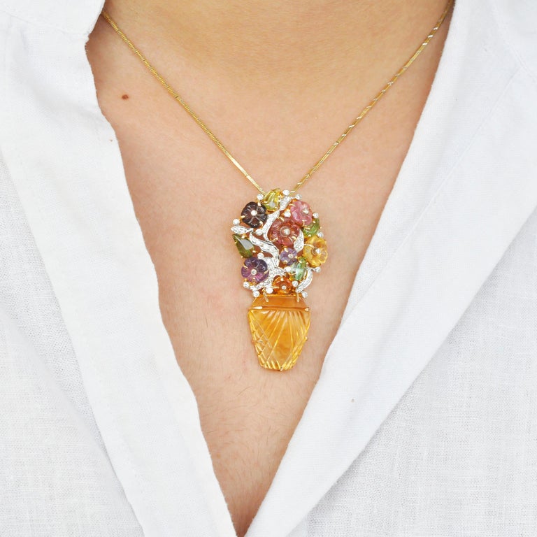 18 karat gold hand-carved citrine tourmaline amethyst diamond bouquet pendant brooch.

Carvings at its best, this 18 karat gold hand carved citrine tourmaline amethyst diamond bouquet pendant brooch, displays one of the finest work by our master