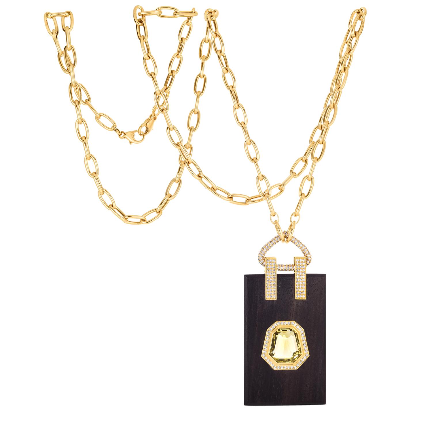 Elevate your style with the 18K Yellow Gold Hand Carved Ebony Pendant, a stunning creation by designer Fern Freeman. This pendant features a beautifully hand-carved ebony centerpiece, paired with a radiant yellow citrine that adds a touch of warmth