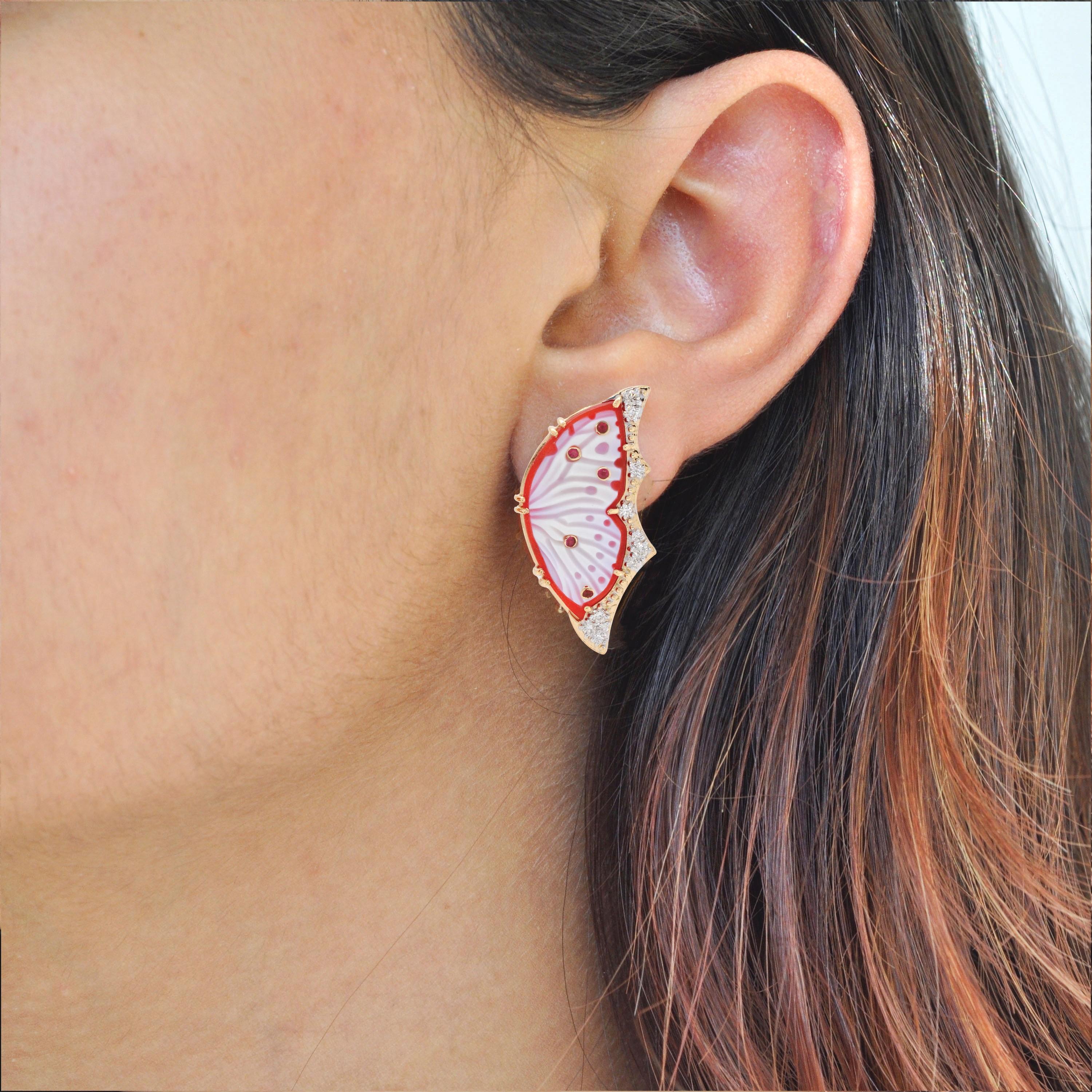18 karat gold agate butterfly carving ruby diamond contemporary stud earrings.

The process of making these studs set in 18k gold with sparkling diamonds, started just like that of a Butterfly. As the little caterpillar goes through the rigorous