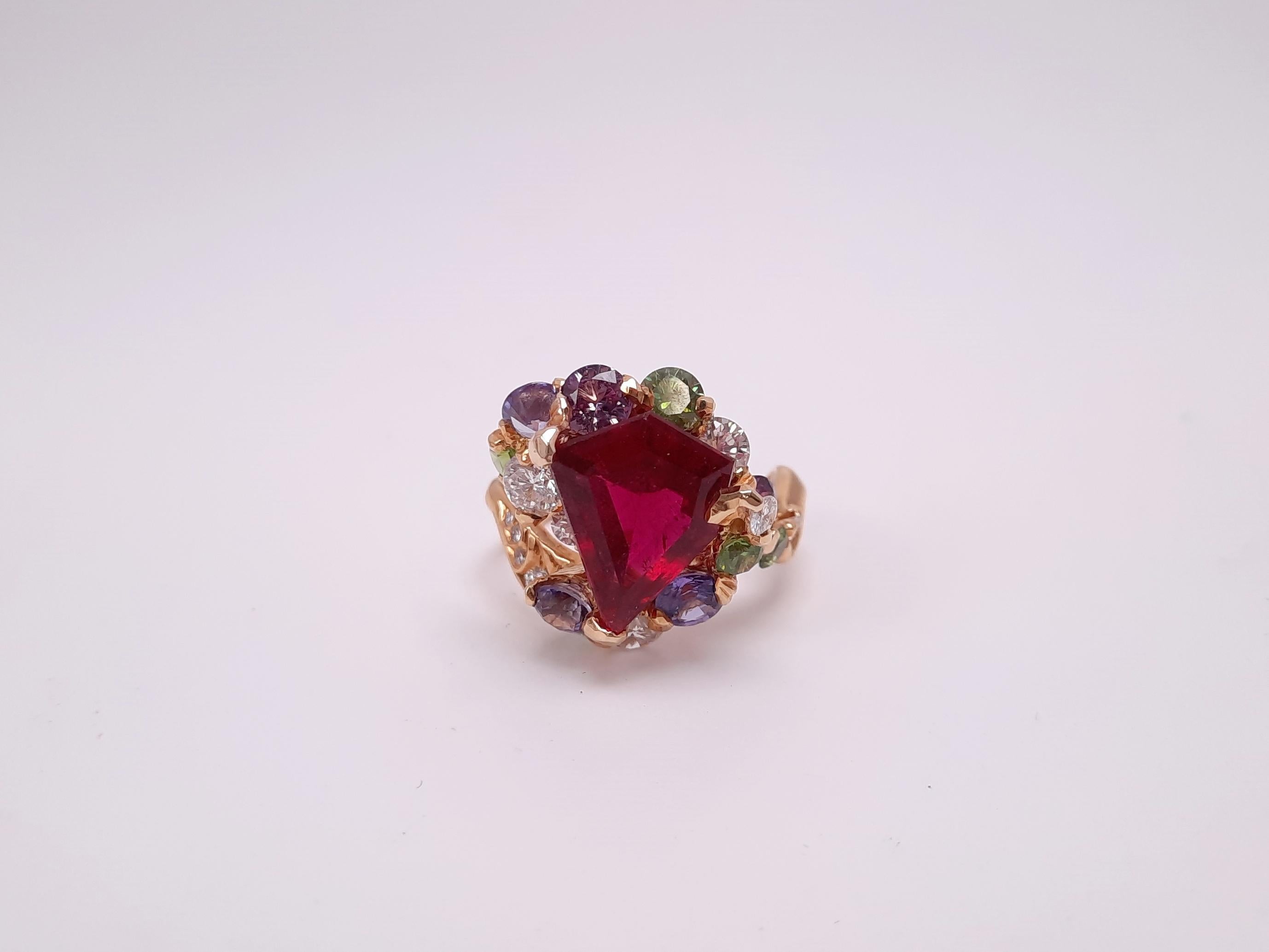 A MOISEIKIN's handmade gold ring with a fancy shape, vivid rubellite, shimmering diamonds, multi-colour sapphires, and rare demantoid garnets reminds you of a sparkling Christmas tree or the New Year decoration for this festive season. The Artful