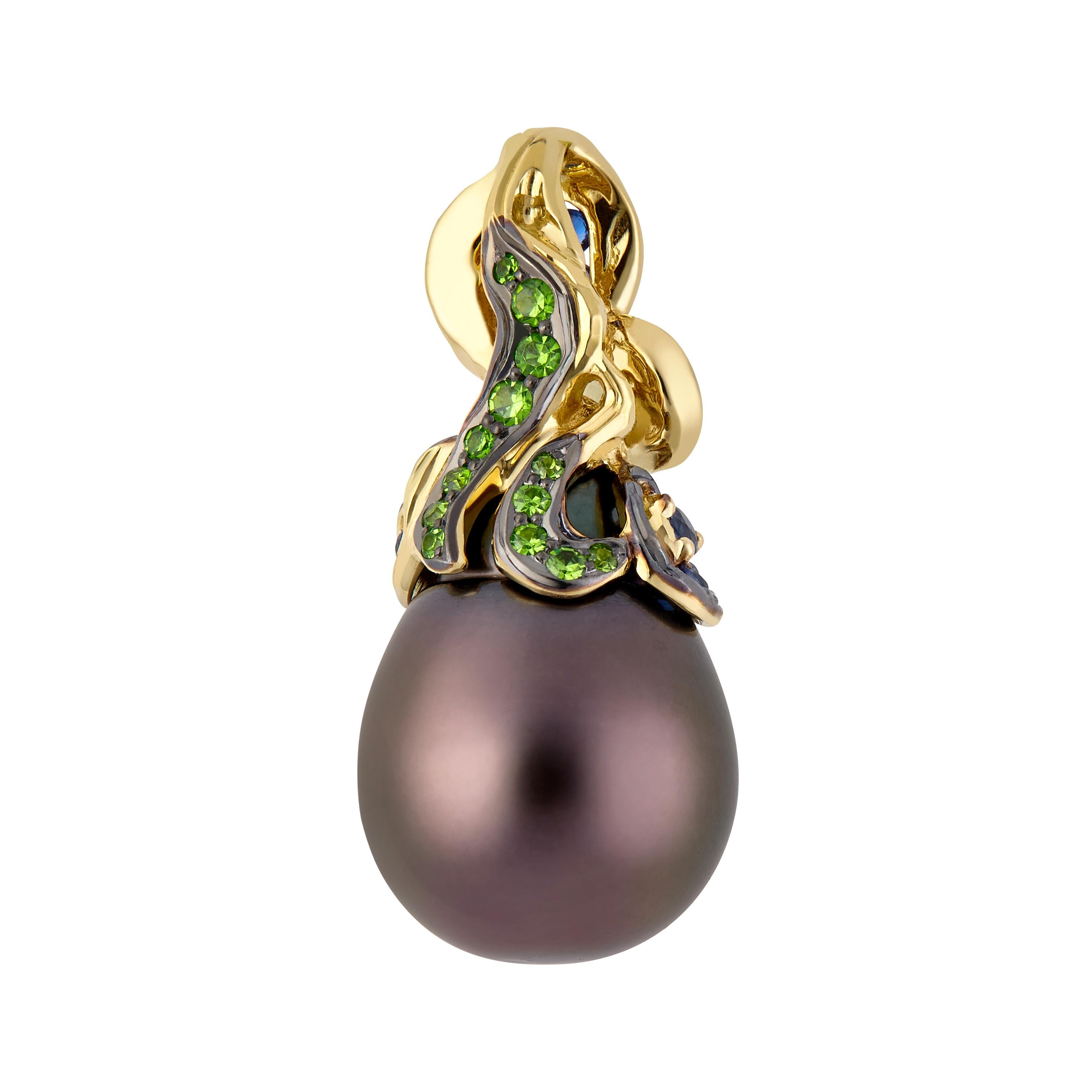 Inspired by impressionism and Vincent Van Gogh, MOISEIKIN created a starry night style pendant with a drop shape Tahitian Pearl, blue sapphires, and rare demantoid garnets. The gold bail with a swirling cloud motif is decorated with radiant blue