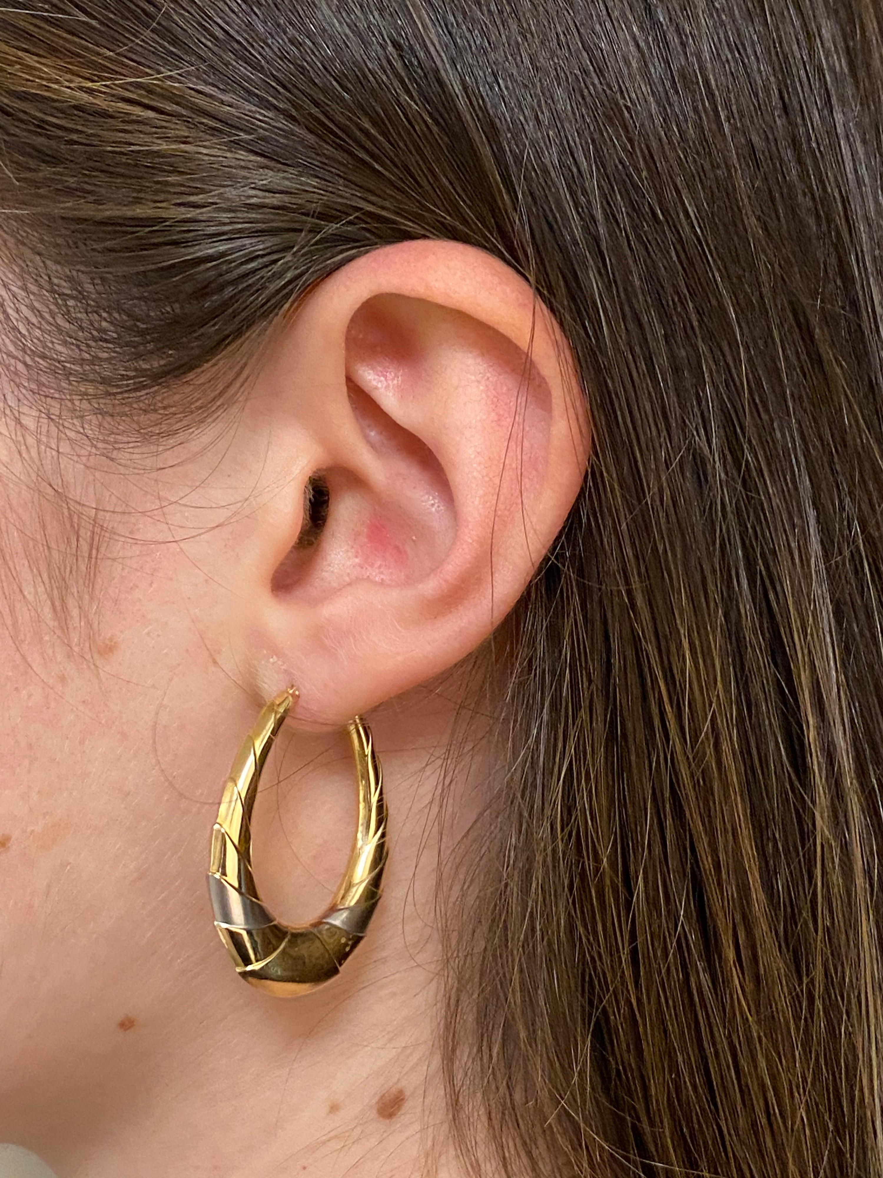18K Gold Hoop Earrings

Earrings
electro-formed which allows the earrings to be light.
A crescent decoration adorns the pretty volume of these.
Each earring weighs 2g, measures at the pendant 3.5cm or 1.378 inch