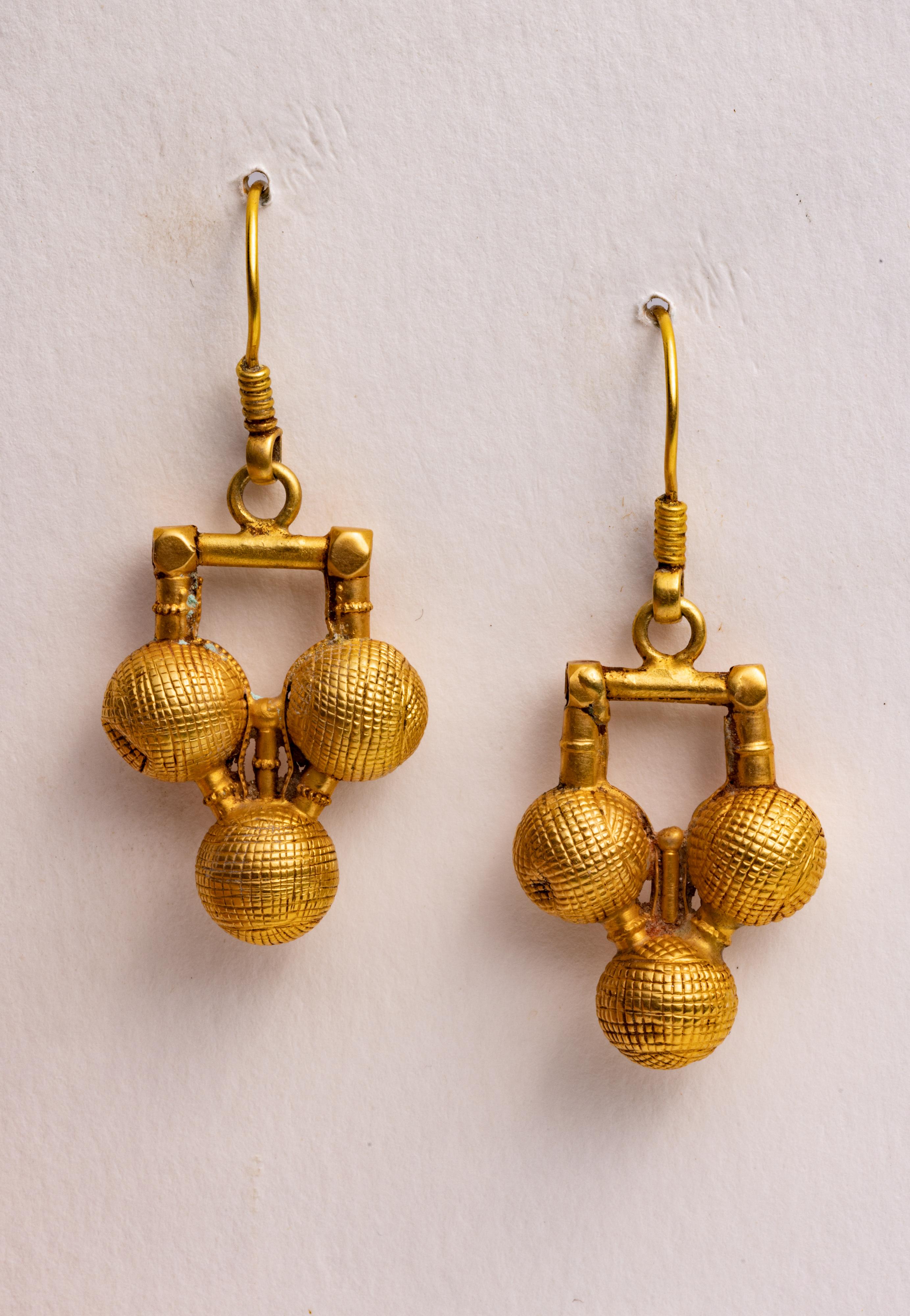 A pair of 18K gold South Indian dangle drop earrings hand-tooled testured design using the lost wax method.  French wire for pierced ears.  

The fine jewelry collection is sourced, designed or created by Deborah Lockhart Phillips. Through her