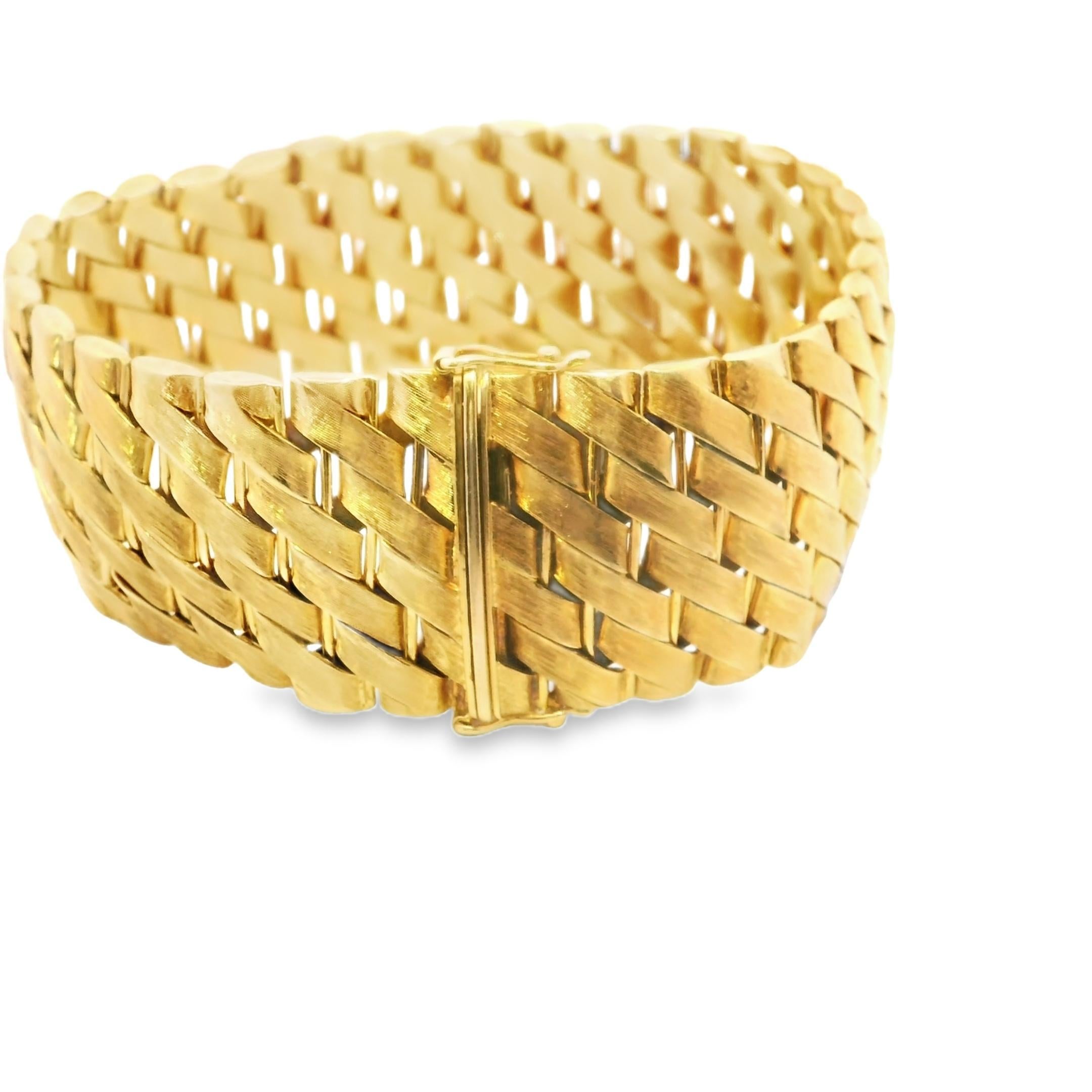 In the realm of gold bracelets, this piece stands as a testament to bold design and craftsmanship. Crafted in 1986, this French bracelet is a striking creation in 18k gold, embodying the audacious spirit of the 1980s.

The wide, interwoven links