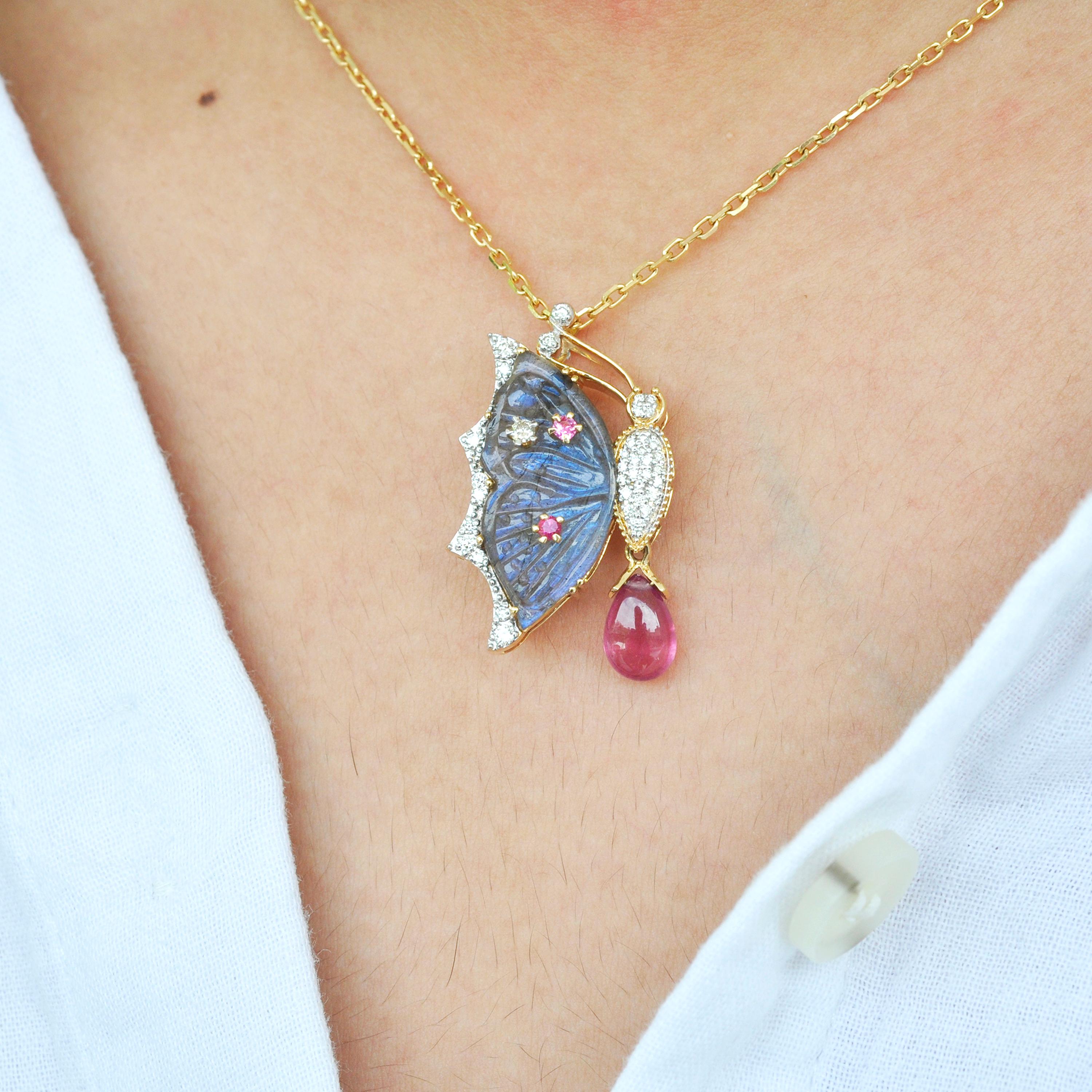 18 Karat gold labradorite butterfly carving pink tourmaline diamond pendant necklace

The process of making this pendant brooch set in 18k gold with sparkling diamonds, started just like that of a butterfly. As the little caterpillar goes through