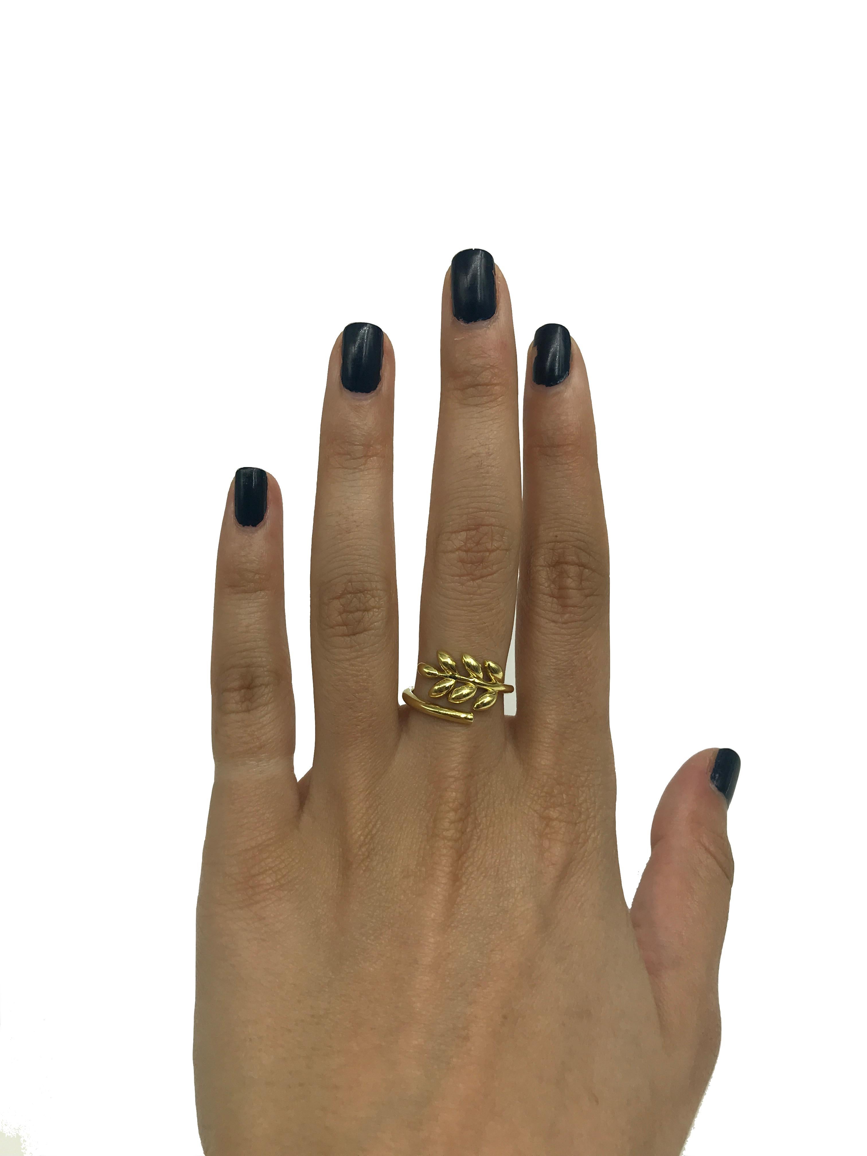 This 18k gold leaf ring is inspired by the organic way nature moves and grows. The fern shaped leaf ring wraps around your finger. The ring is a size 6. 