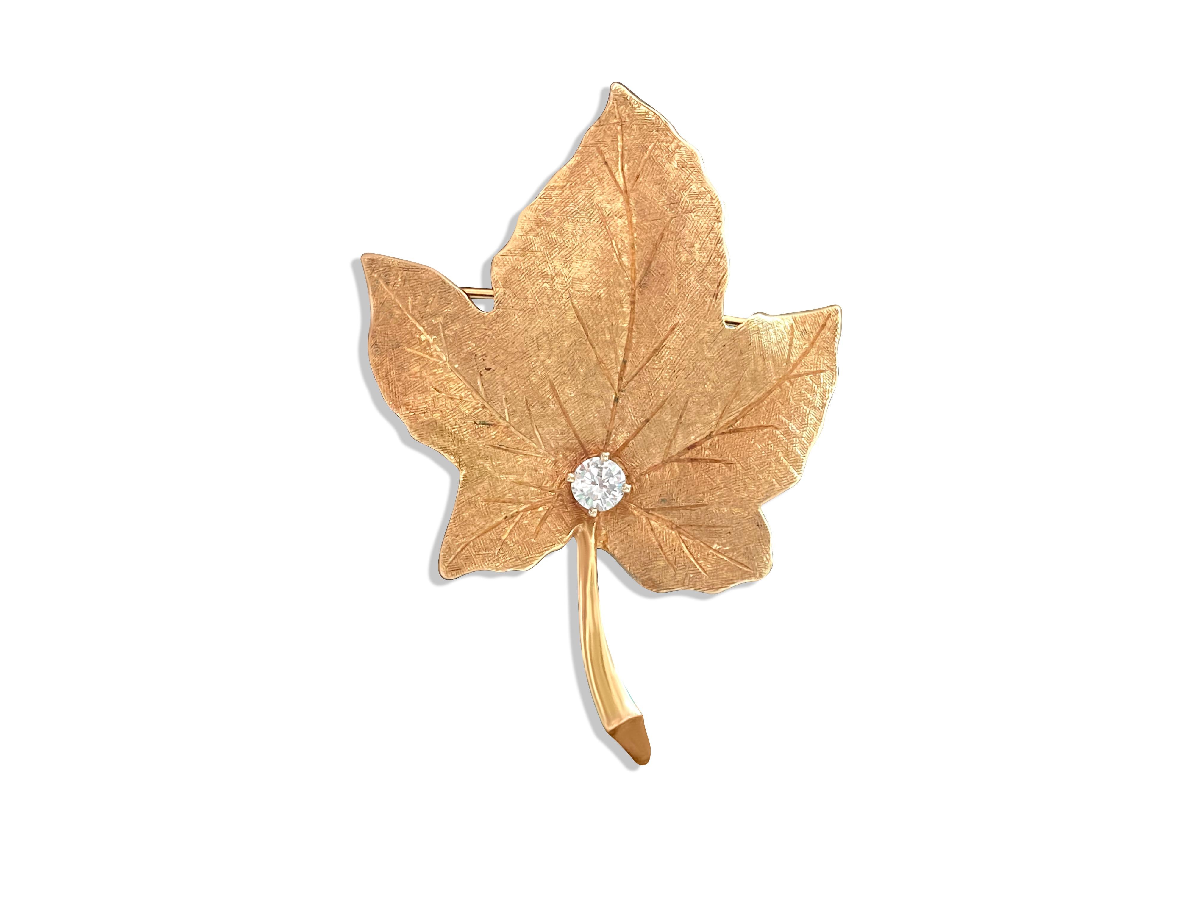 Fashioned from radiant 18k yellow gold, this captivating maple leaf brooch exudes timeless elegance. Adorning its intricate design is a dazzling 0.50 carat diamond, boasting VS clarity and F color, ensuring its natural brilliance. With its exquisite