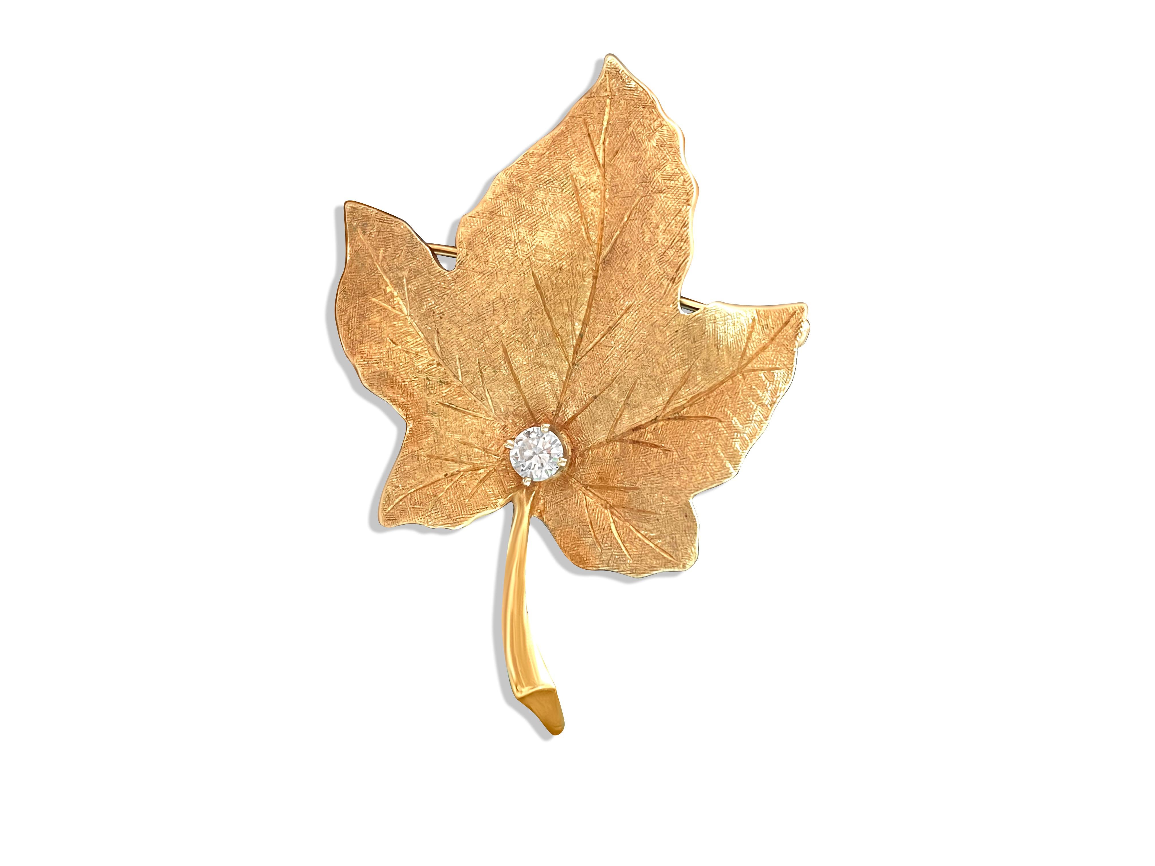 Fashioned from radiant 18k yellow gold, this captivating maple leaf brooch exudes timeless elegance. Adorning its intricate design is a dazzling 0.50 carat diamond, boasting VS clarity and F color, ensuring its natural brilliance. With its exquisite