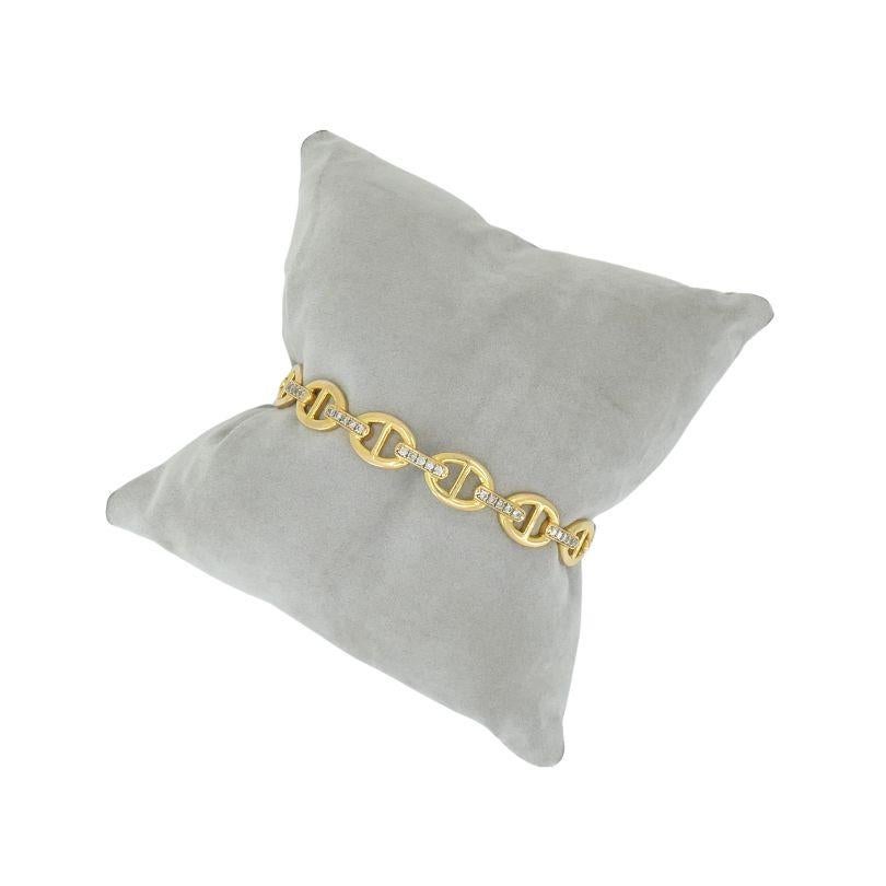 This circa 1990s 18k gold diamond mariner cuff bracelet is a beautiful piece to add to any wrist stack or be worn alone for an understated simplistic look. The bracelet is 7 1/4