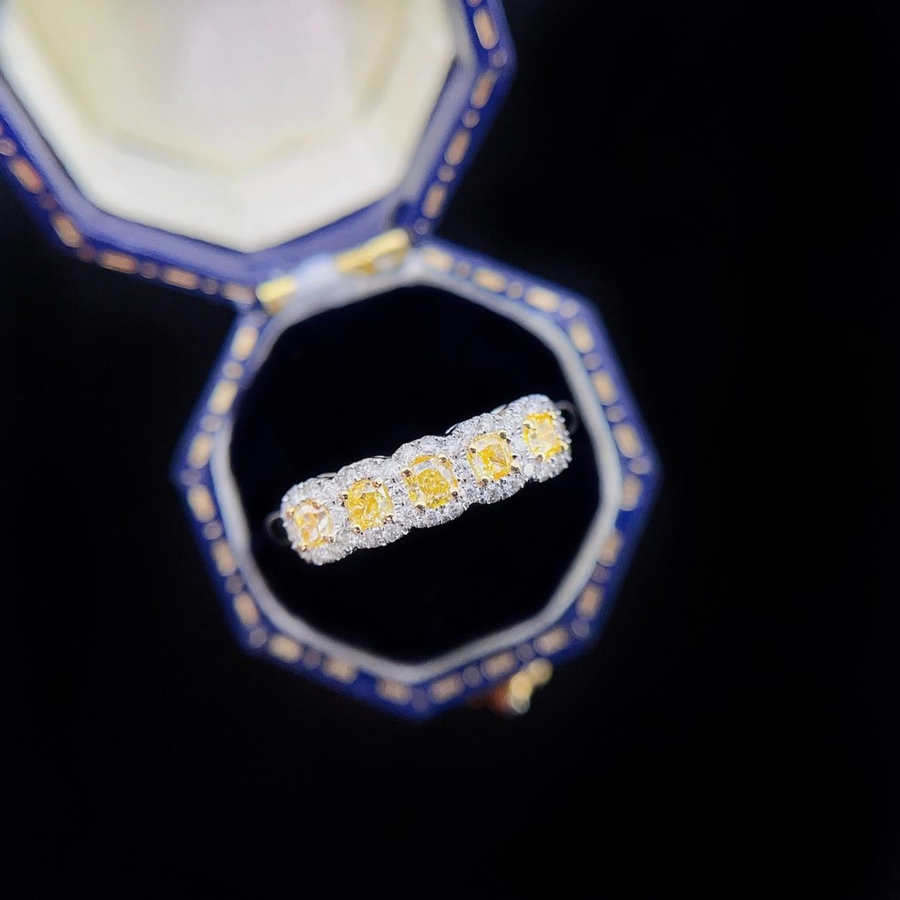 18k Gold Modern Ring Rare White and Yellow Diamonds in a Cushion
Total Weight: 2.8 g
Net Gold Weight: 2.69 g
Main Stones: 5 Yellow Diamonds, 0.380 CT
Secondary Stones: 38 White Diamonds, 0.170 CT
This exquisite ring showcases a contemporary design