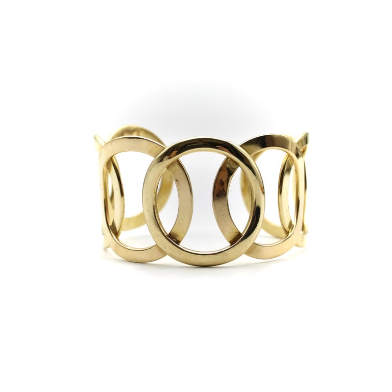 Reminiscent of the Olympic rings, this fabulous cuff bracelet consists of a center circle mirrored by circles layered on each side. Circa the 1970’s, this modernist bracelet uses negative space to create a bold presence on the wrist, while still