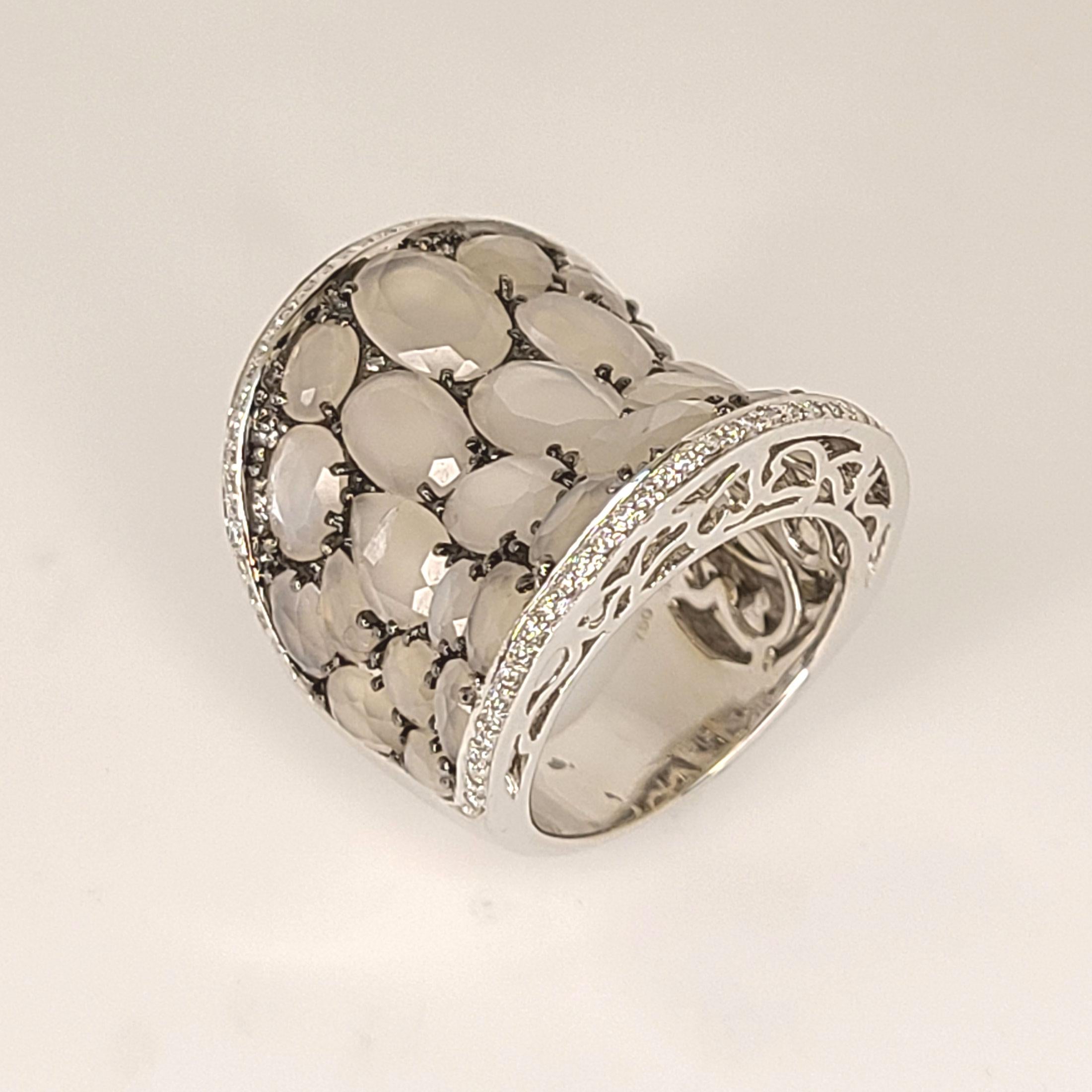 This 18K white gold moonstone ring is made in 2013. This is one of a kind ring and has no continuation. This ring is for long fingers and would perfectly fit to sizes 7 to 7+. It may be slightly sized upon order. In between stones, the gold prongs