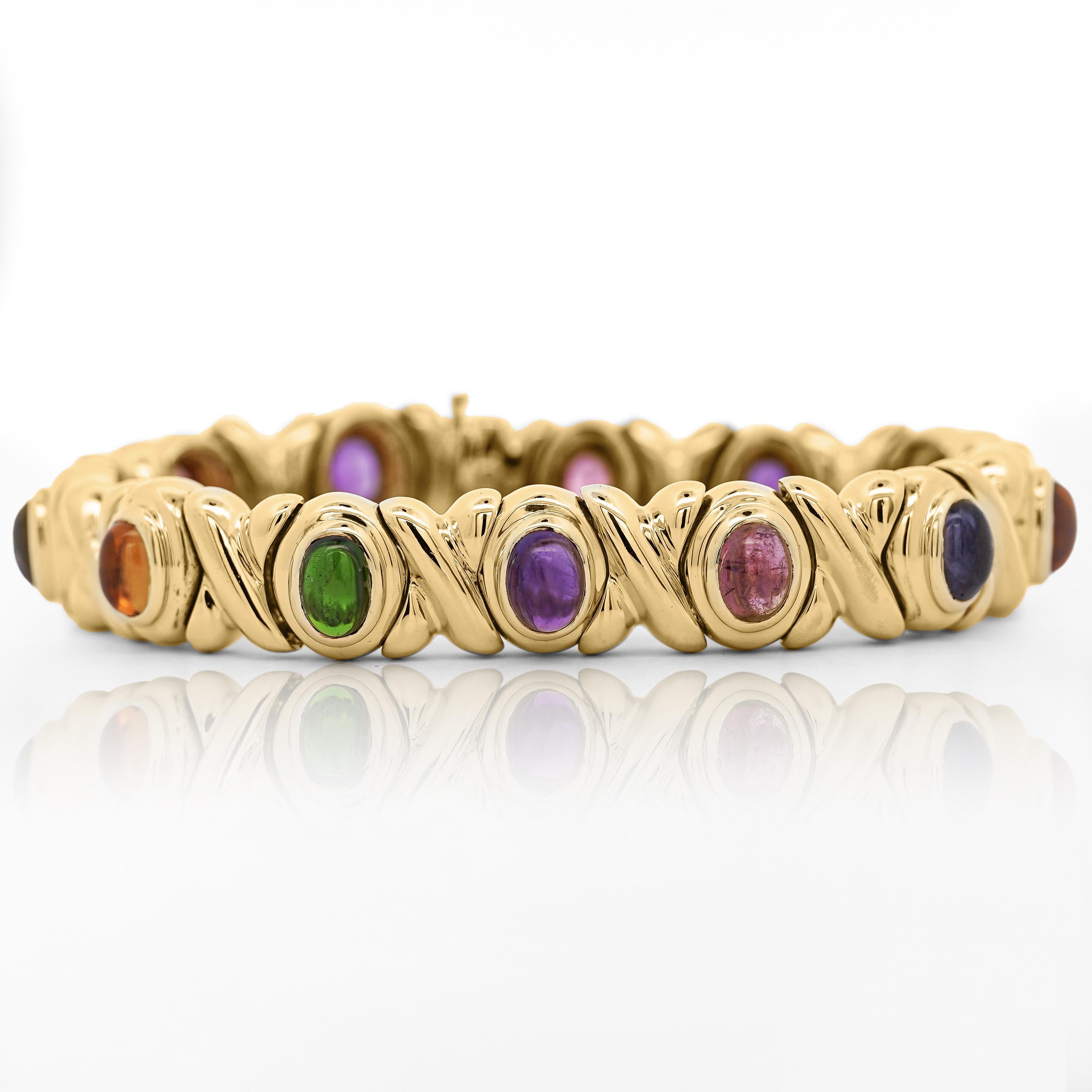 Ce bracelet vintage en or jaune 18 carats présente une combinaison de pierres précieuses serties, dont la tourmaline, l'améthyste, l'iolite et la citrine.

Détails :
Type d'article : Bracelet
Métal : Or jaune 18K
Réglage : Lunette
Pierres précieuses