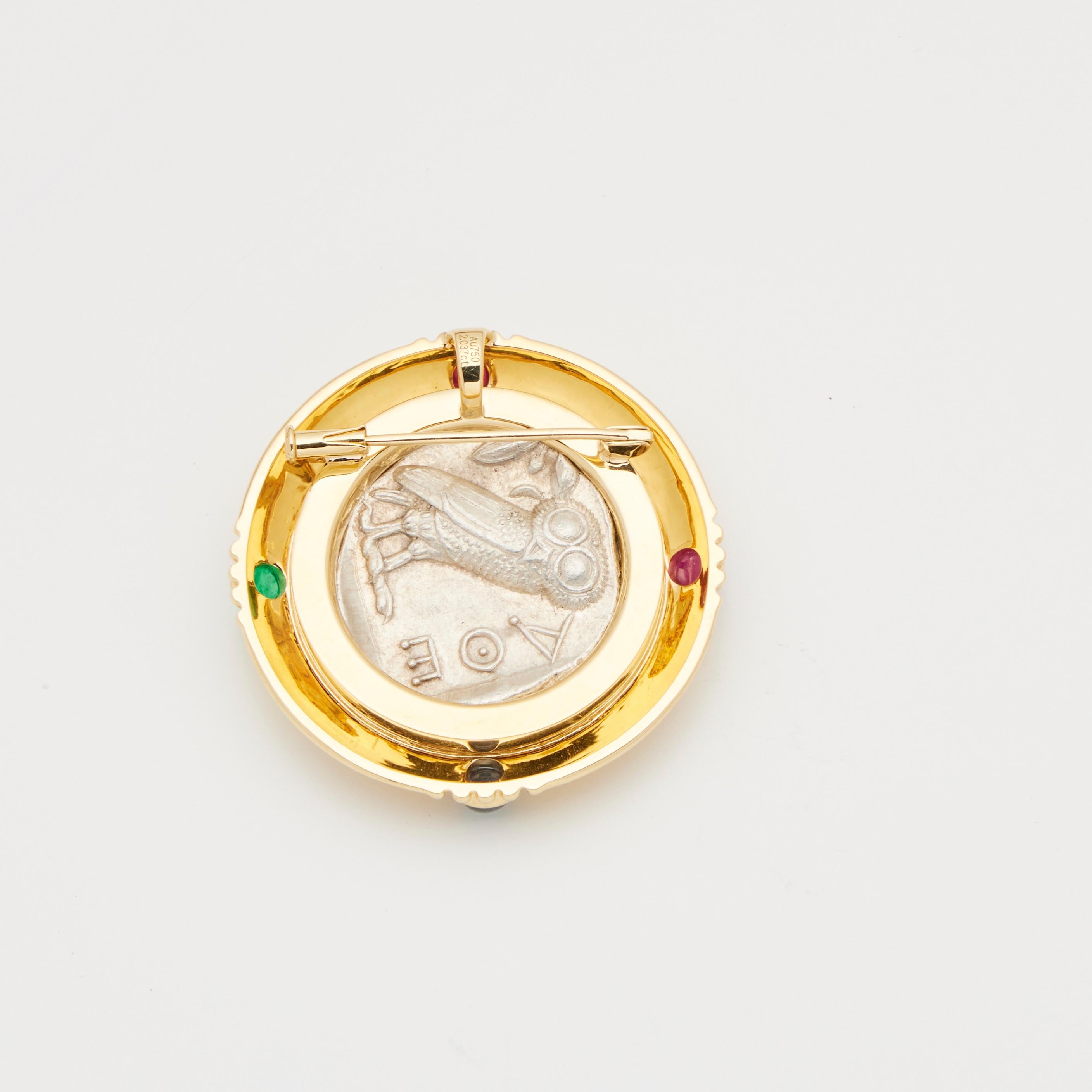18-karat yellow gold
Ancient, authentic Greek silver coin center inset
Decorate with multi-gemstone 1.947 ct
Can be used as pendant
Total weight is about 34.33g
1.5 *1.5 inches