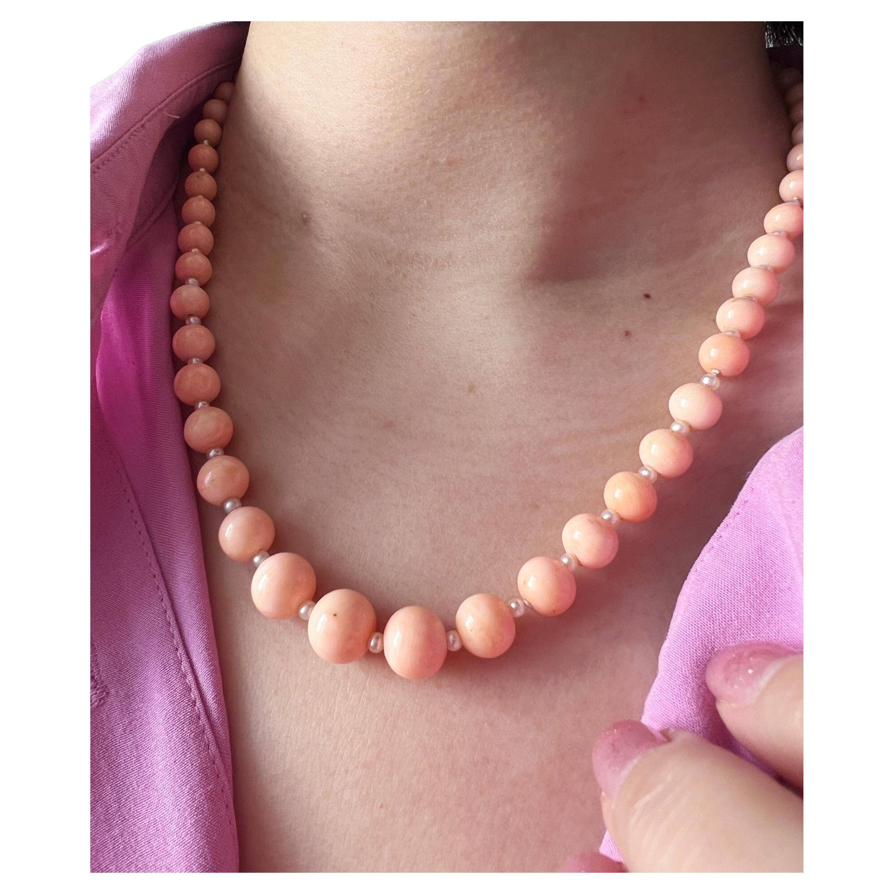 As gentle as a spring breeze, this very beautiful pink angel skin coral and pearl necklace is an easy to wear piece of jewelry which gets you ready for the upcoming Spring!

This graduated strand is composed of 55 pink coral beads measuring from 5mm